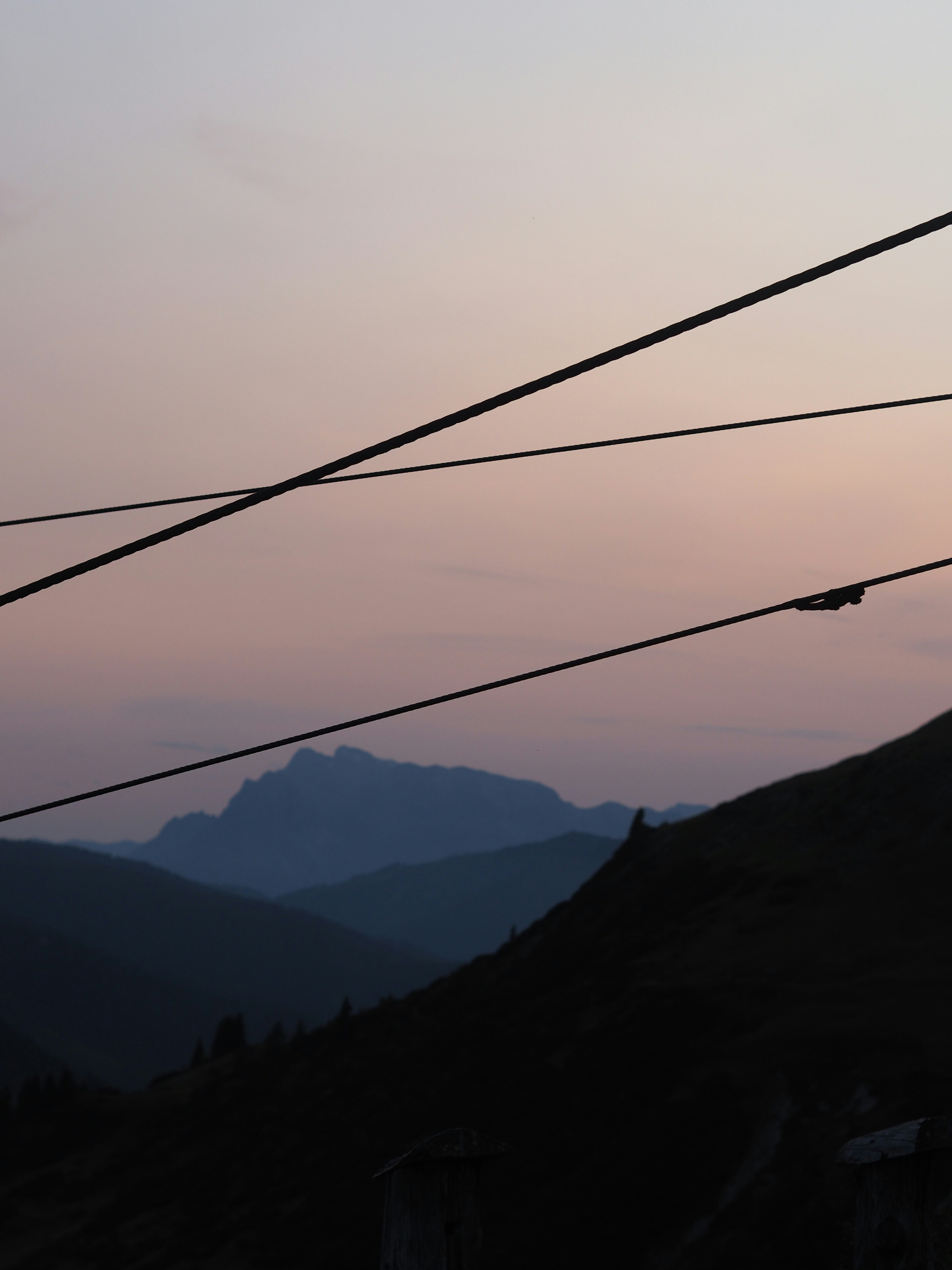 Distant mountains silhouetted against a soft twilight sky.