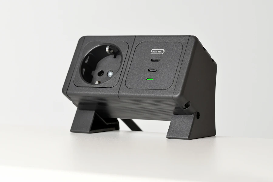 Black electrical adapter with two outlets and USB ports