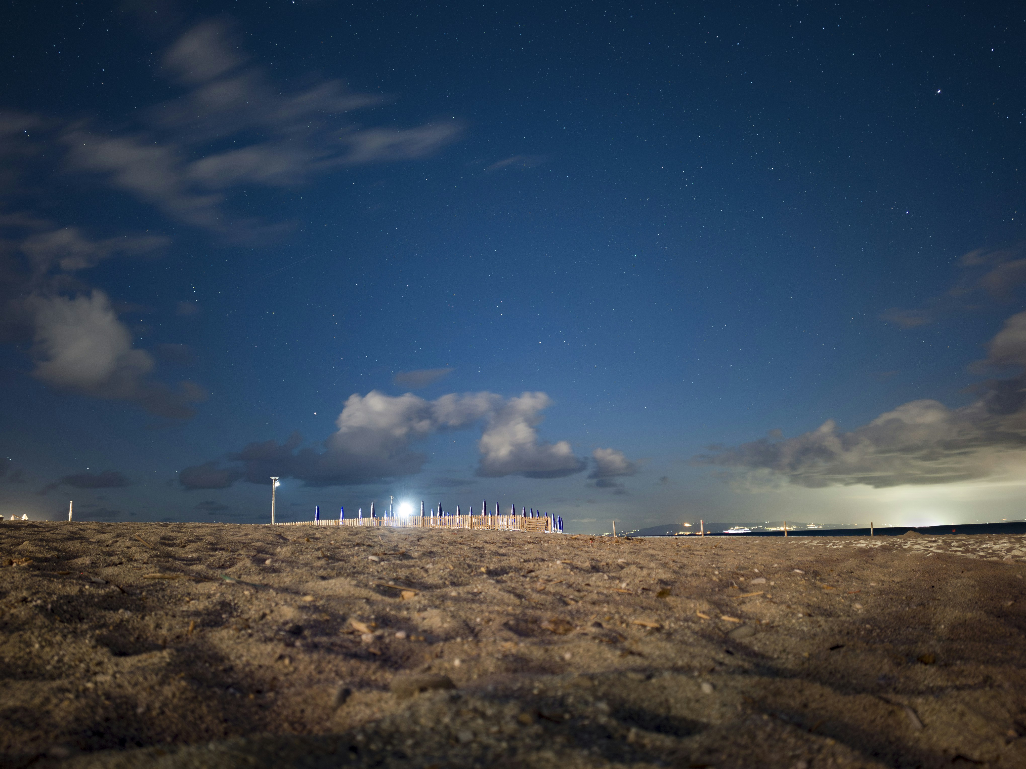 Sandy beach under a starry night sky