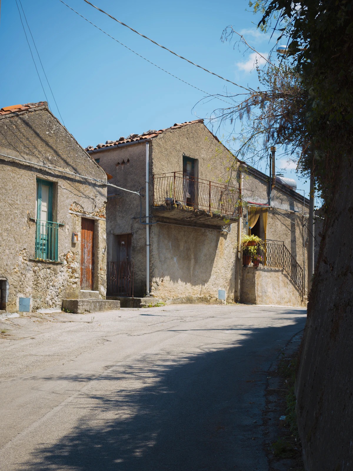 Old stone houses in a sunny Sicily village street