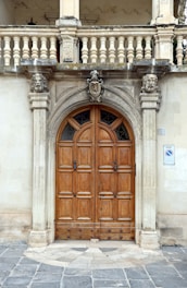 A grand wooden doorway with ornate stone carvings.
