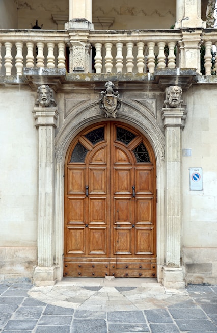 A grand wooden doorway with ornate stone carvings.