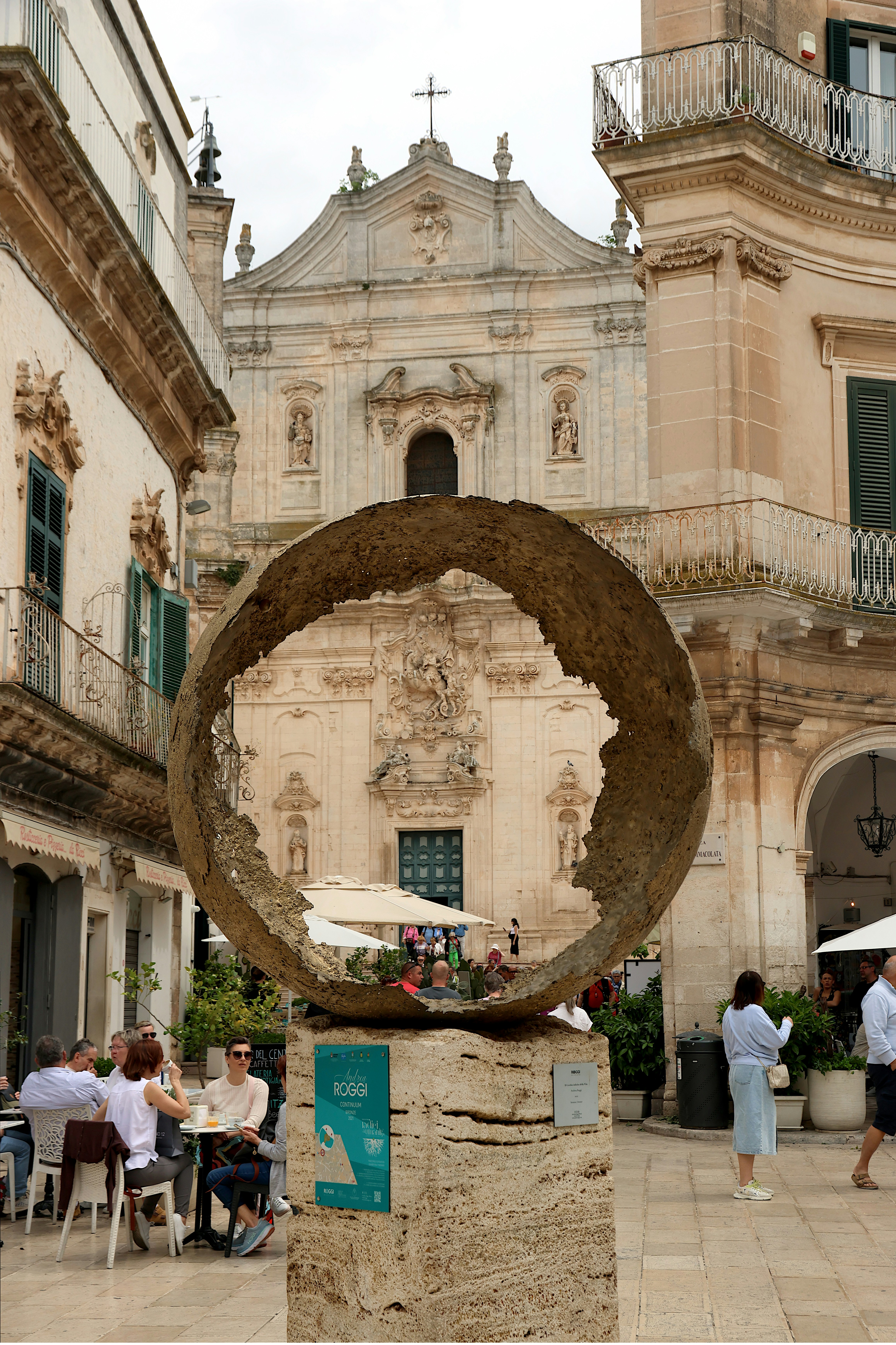 Sculpture in town square with church in background