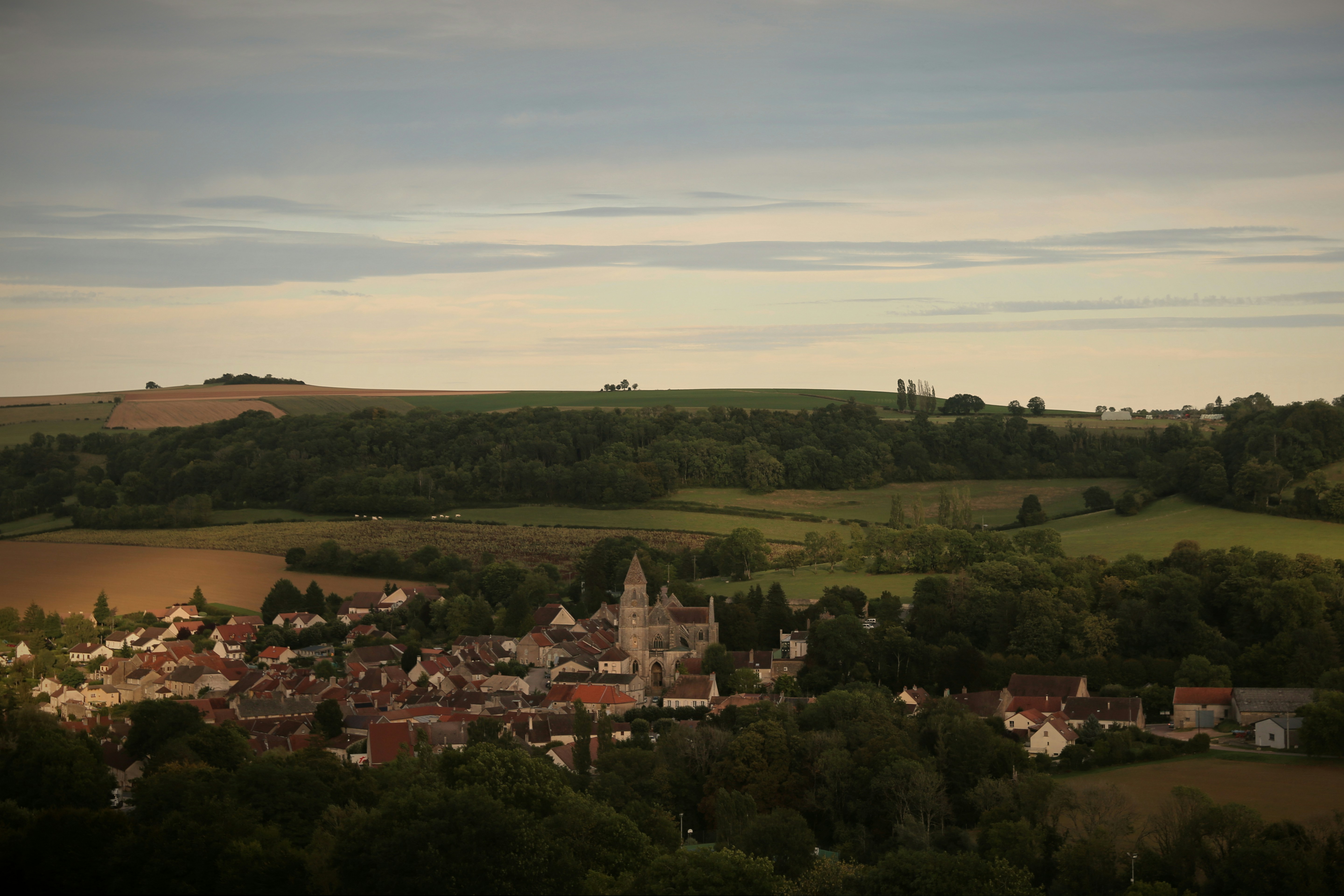 Small village nestled among rolling green hills.