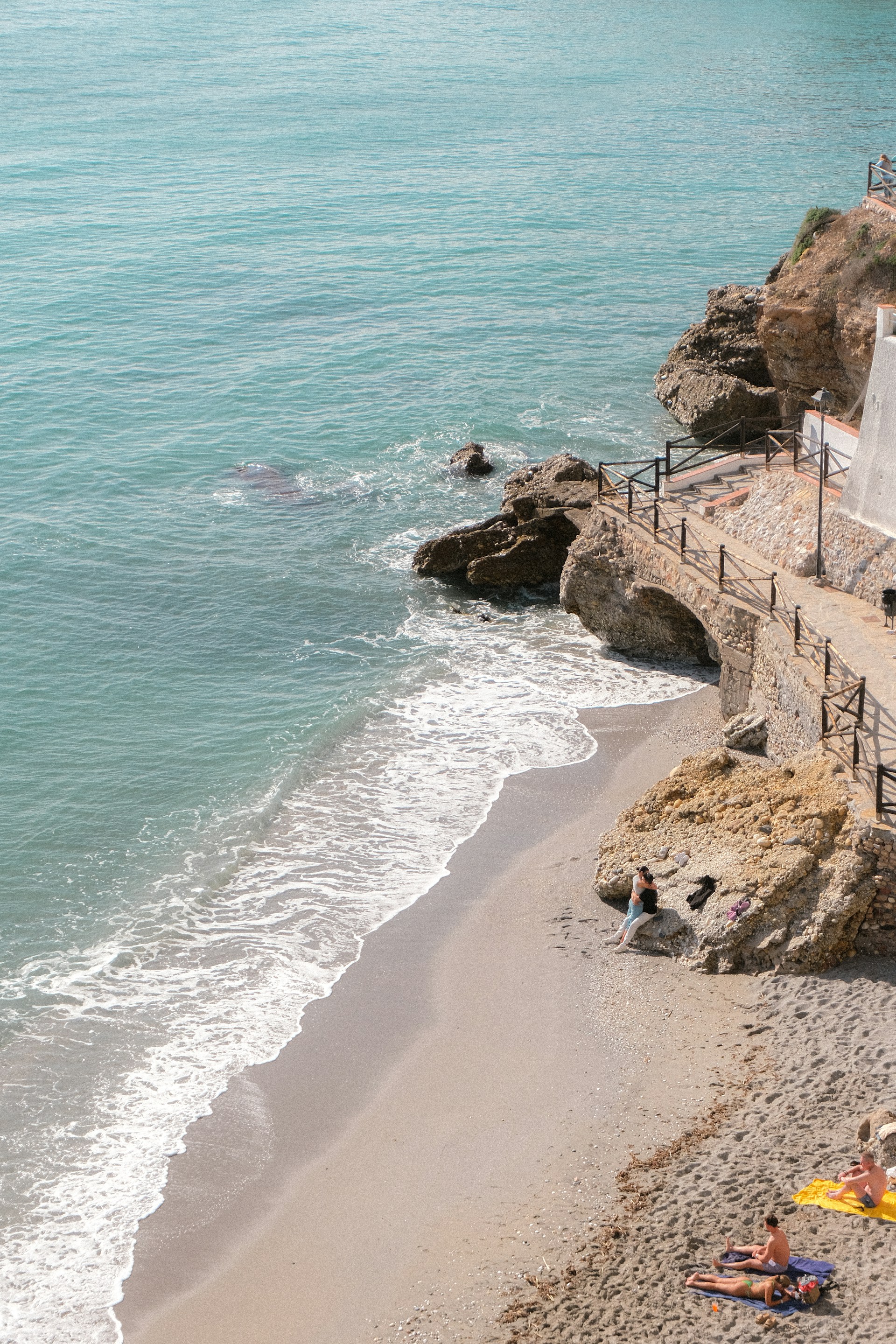 Beach with turquoise water and rocky cliffs