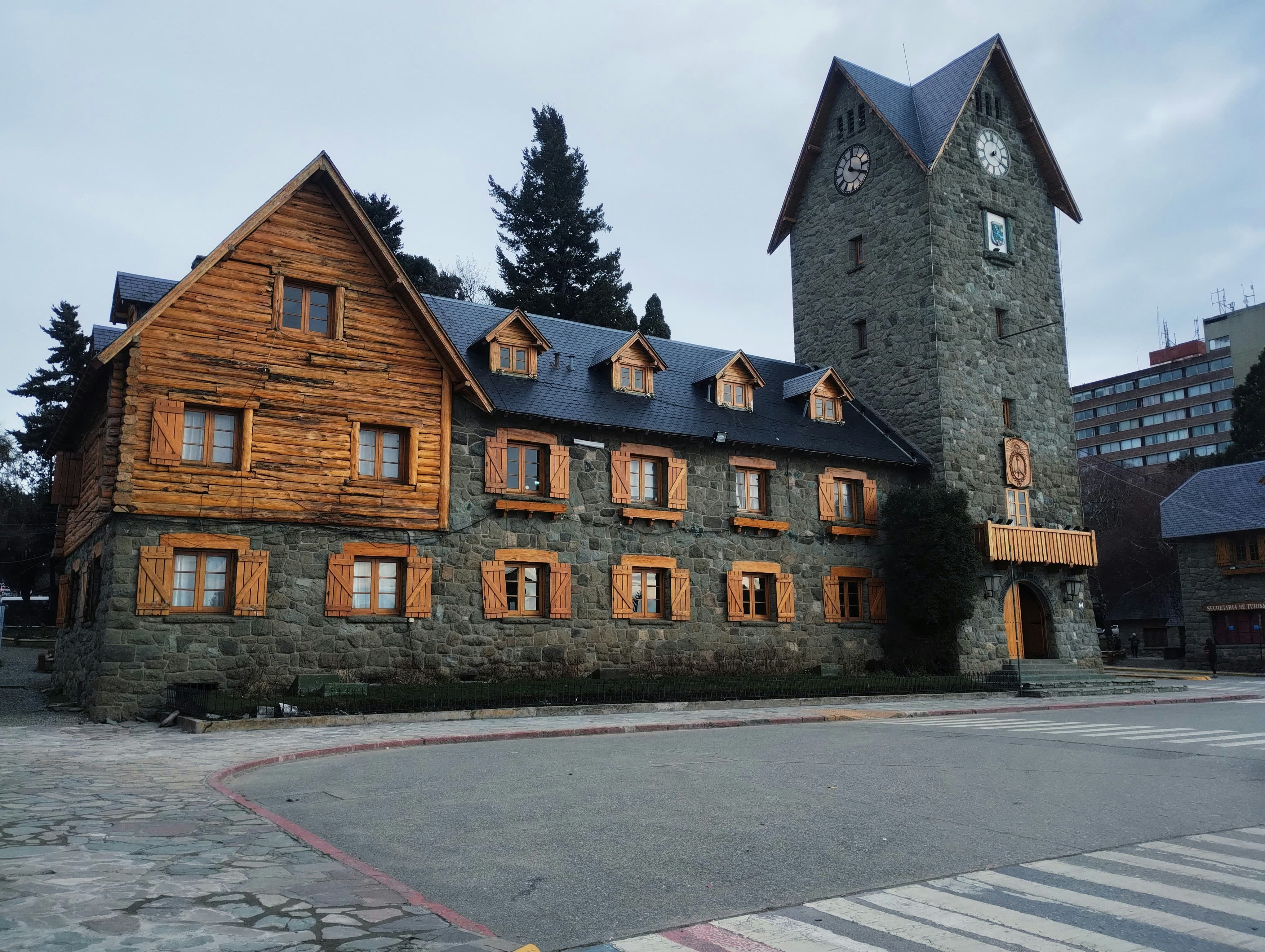Rustic stone and wood building with a clock tower.