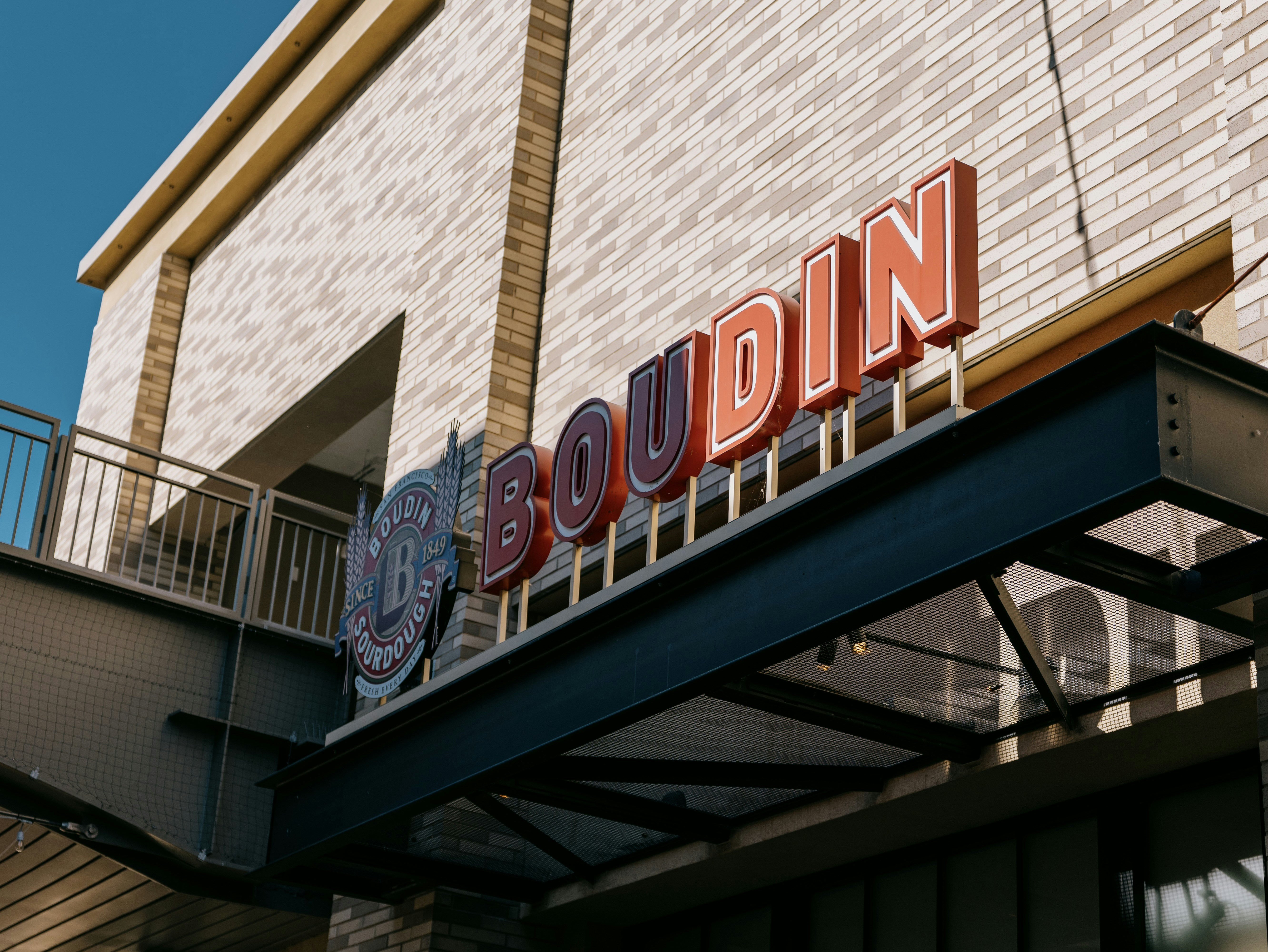 Boudin bakery sign on a brick building