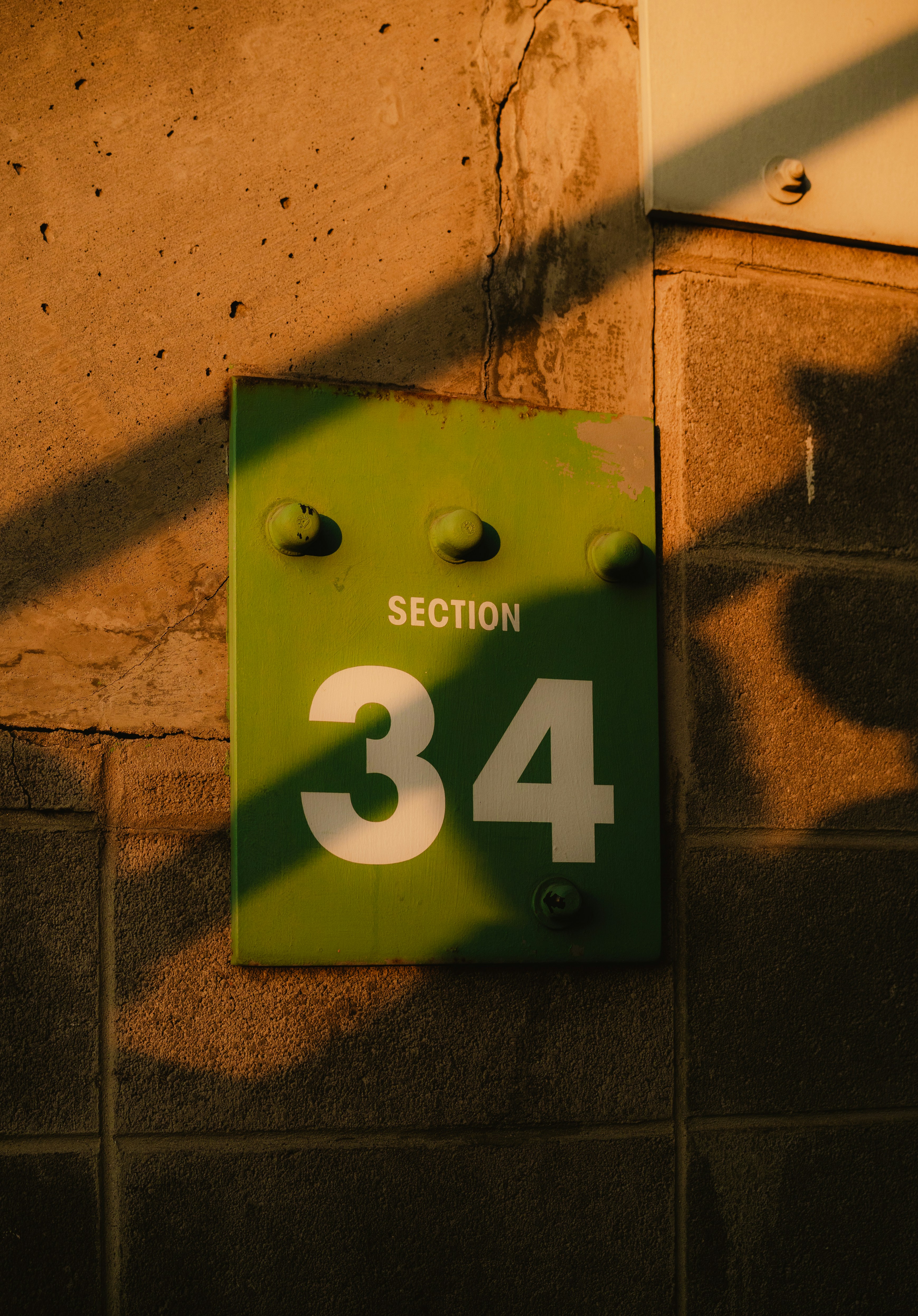 Green sign with section 34 and shadows