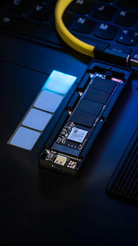 Disassembled ssd drive with memory chips and circuit board.