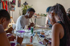 People painting at a table in an art class