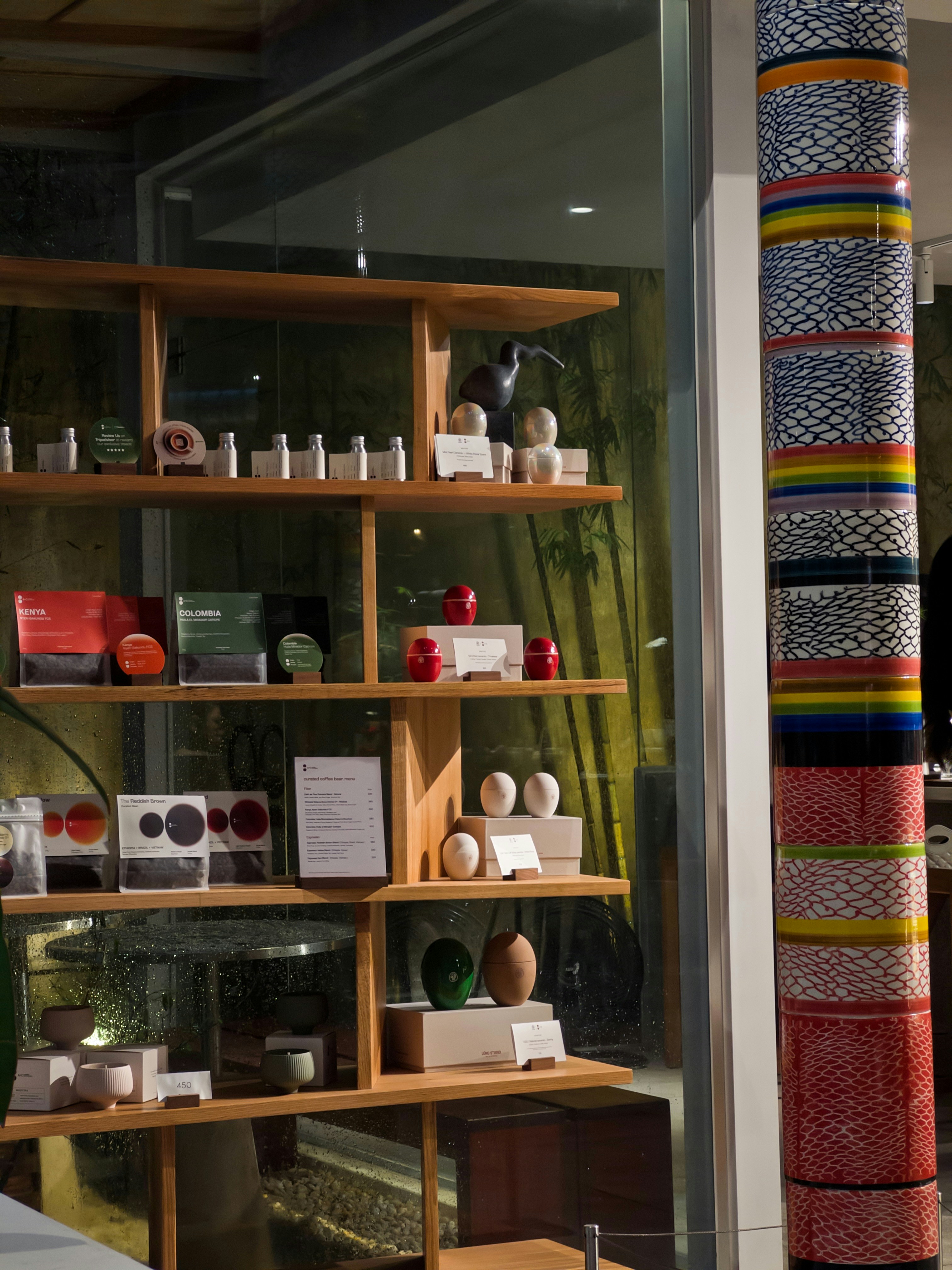 Shelves display various items in a store window.