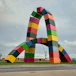 Large colorful shipping container sculpture shaped like letter a