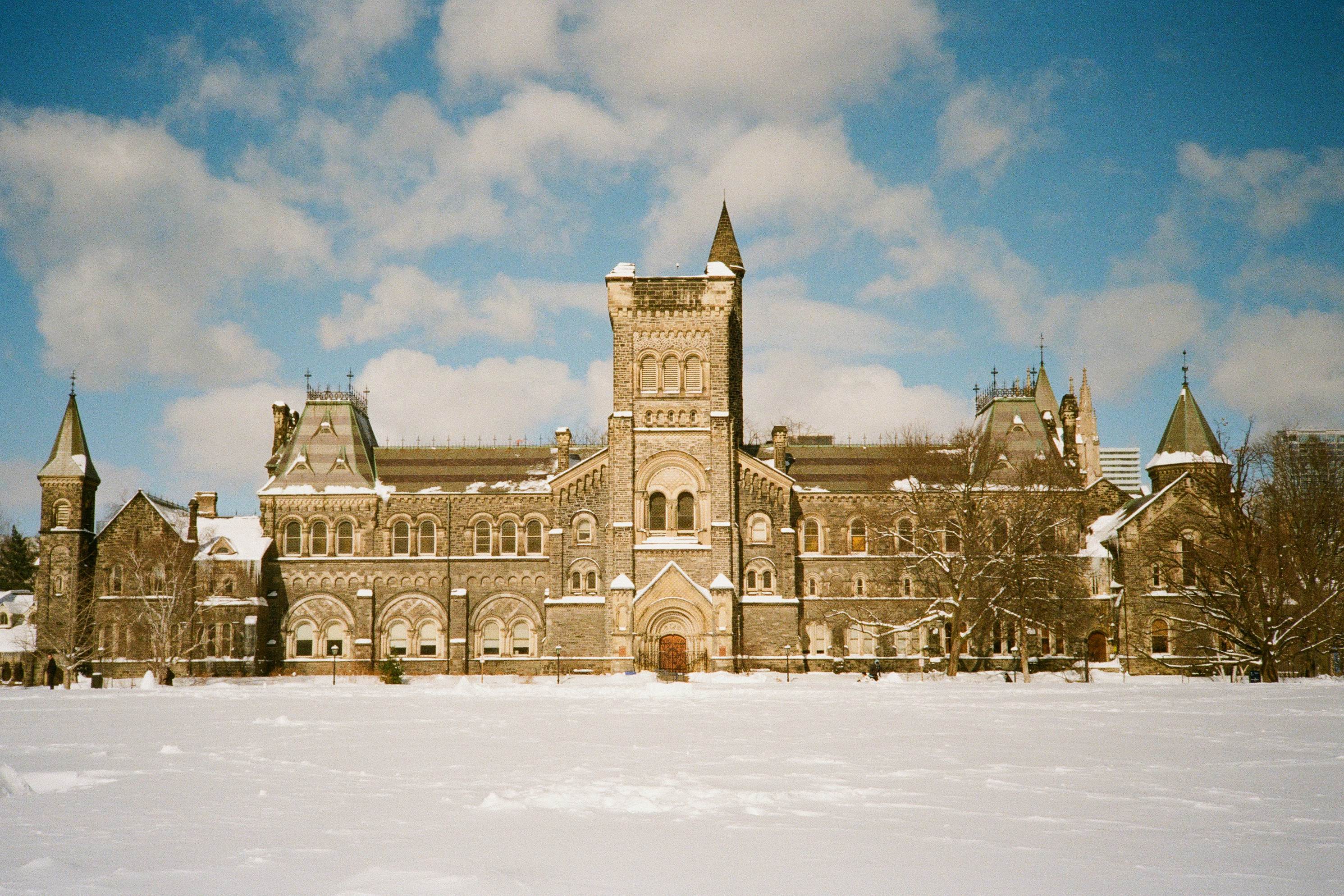 Grand stone building with snow on the ground