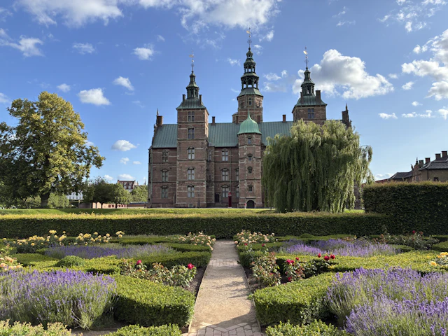 Rosenborg Castle's red-brick Renaissance towers seen beyond its formal rose garden