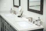 Modern double vanity with sinks and mirrors.