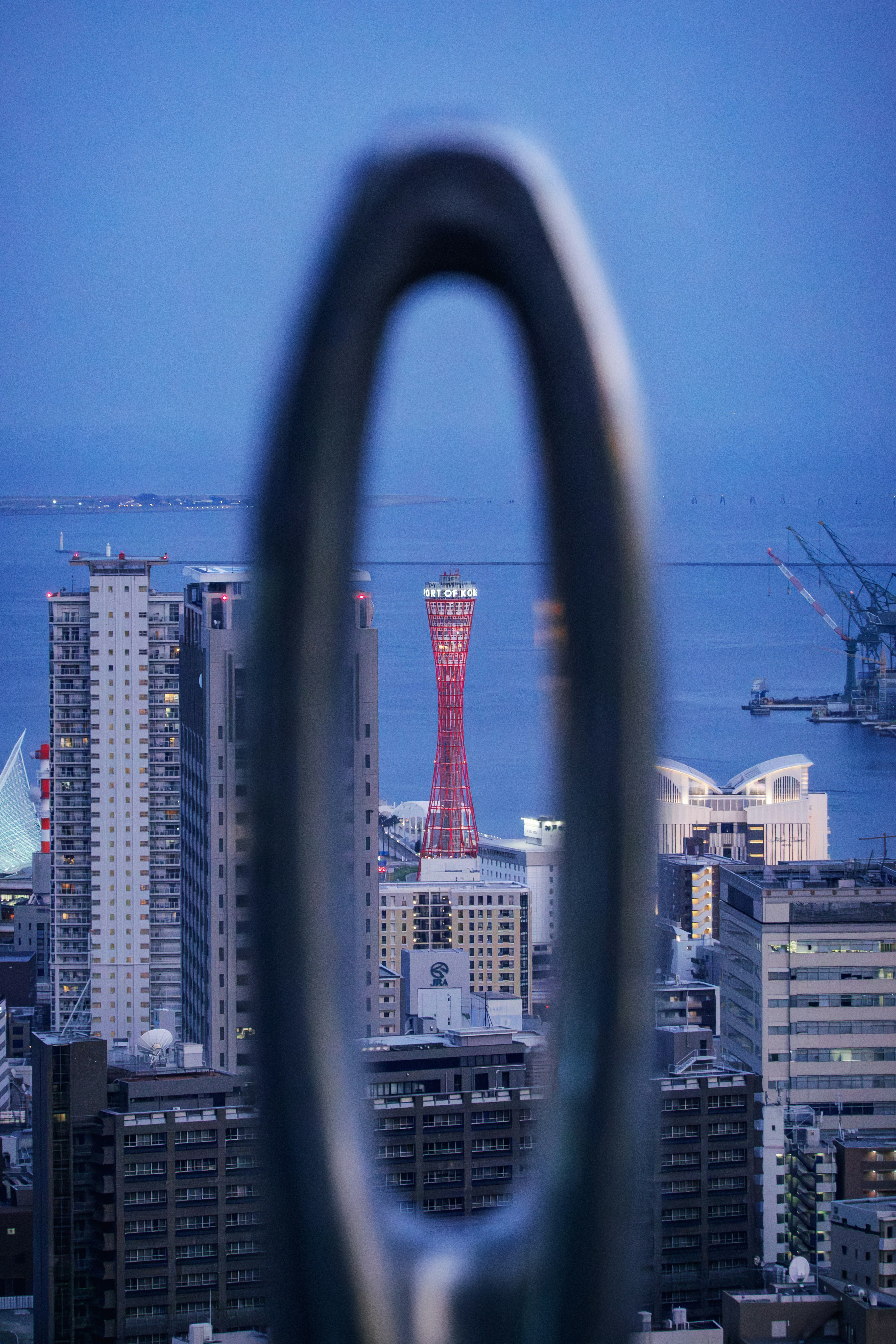 Cityscape with a tall red tower and buildings
