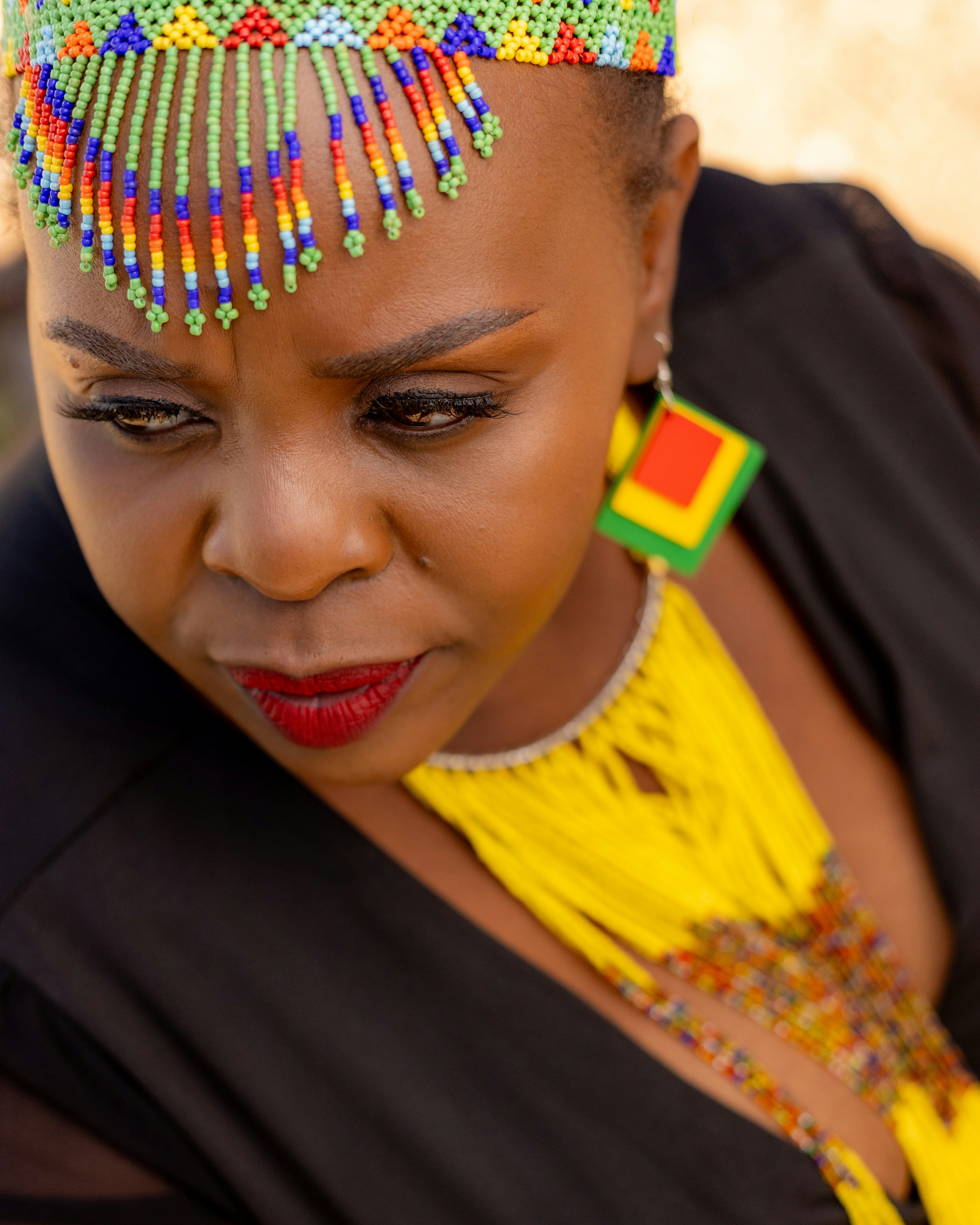 Woman wearing colorful beaded headdress and jewelry
