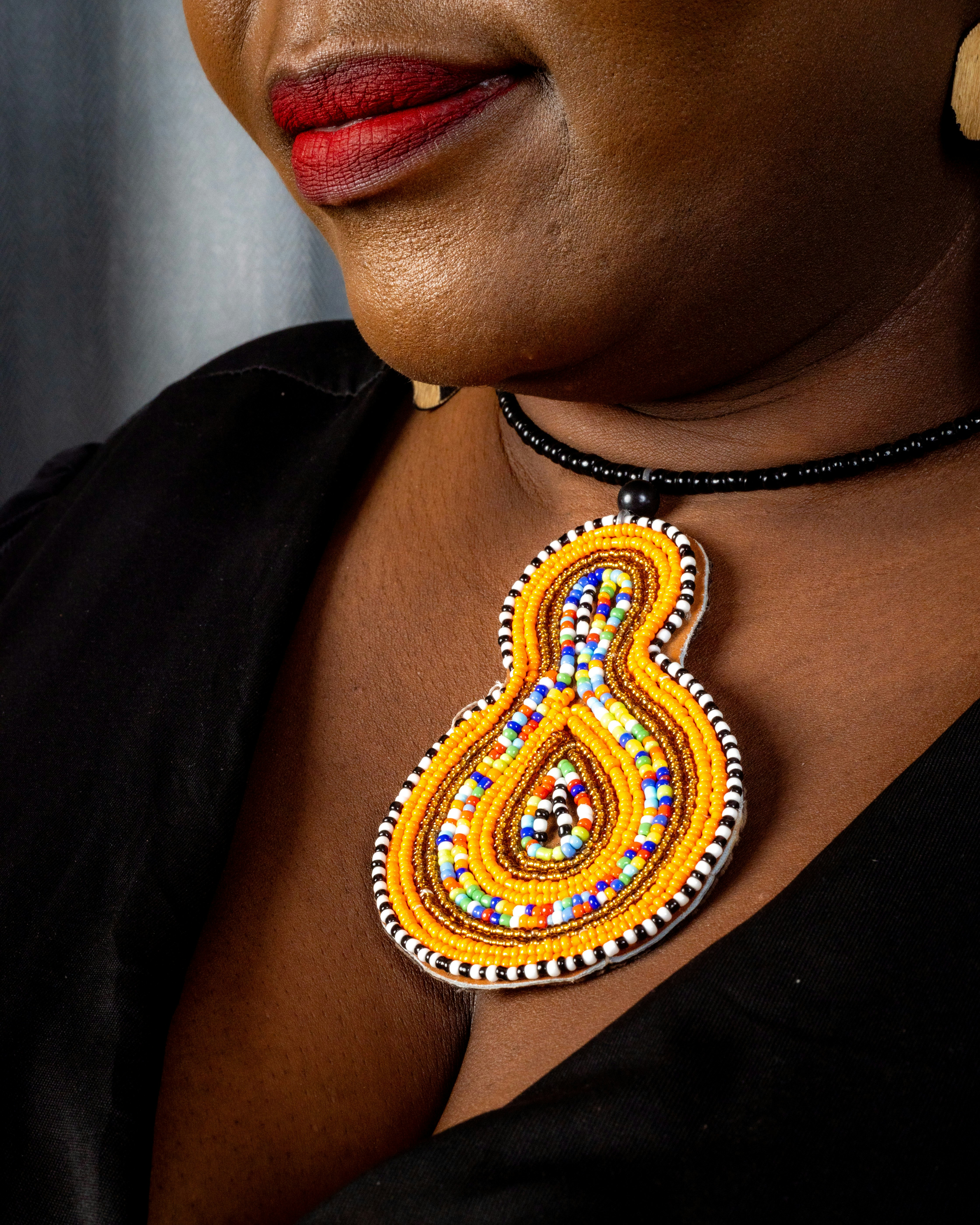 Woman wearing a colorful beaded pendant necklace
