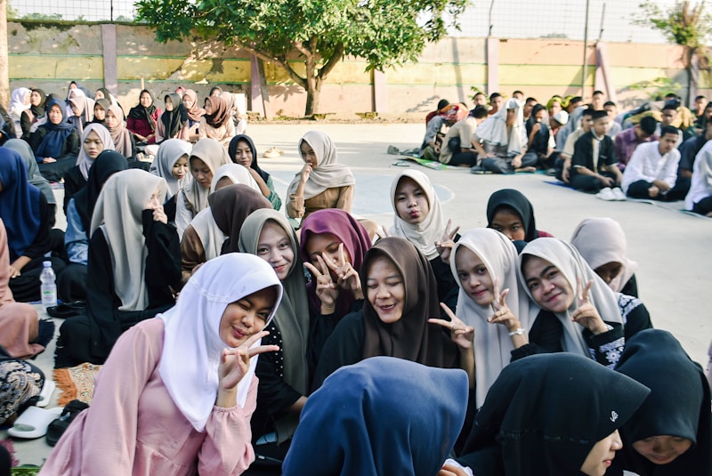 A group of young women in hijabs posing for a selfie.