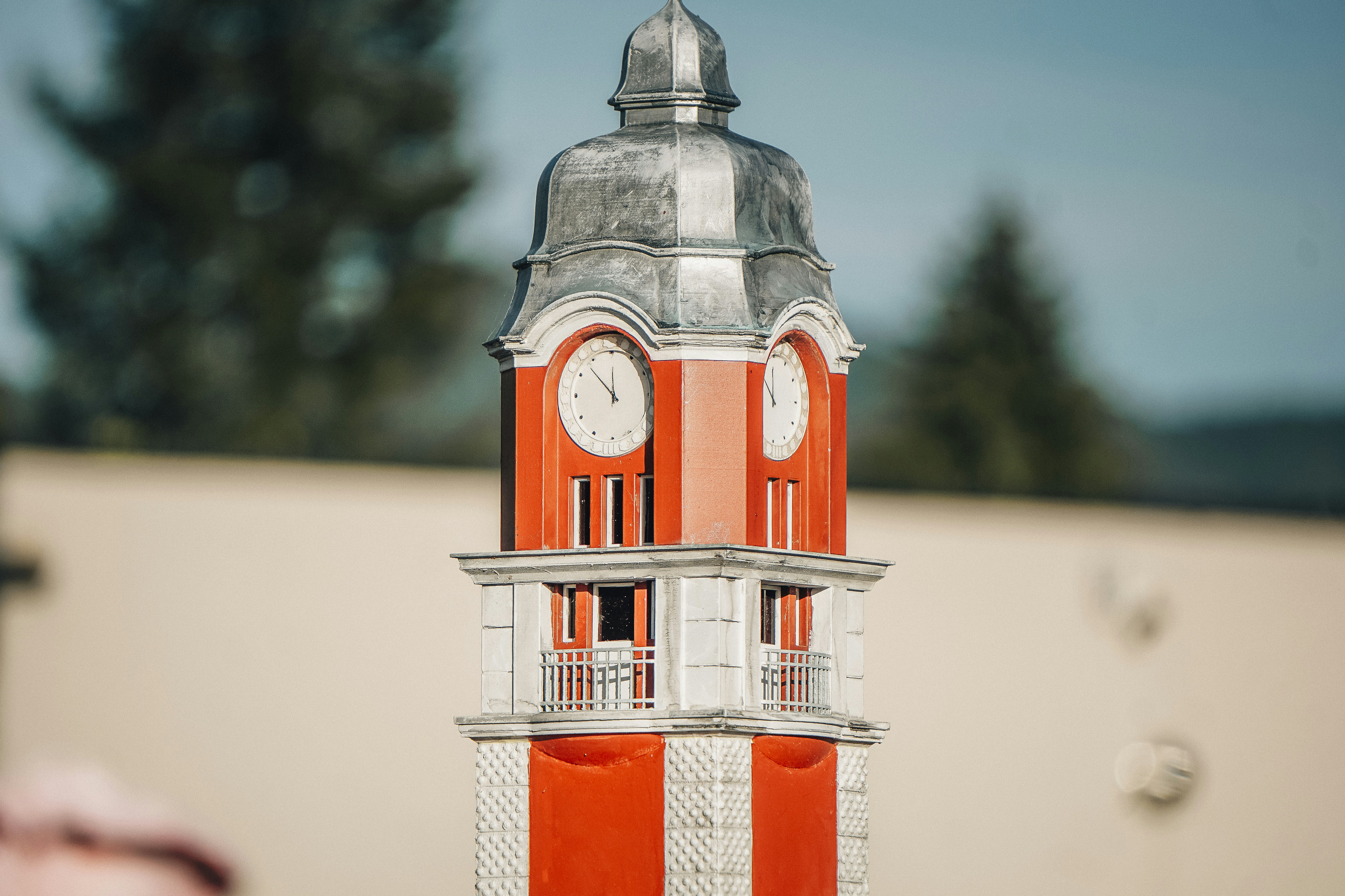 A detailed model of a red and white clock tower.