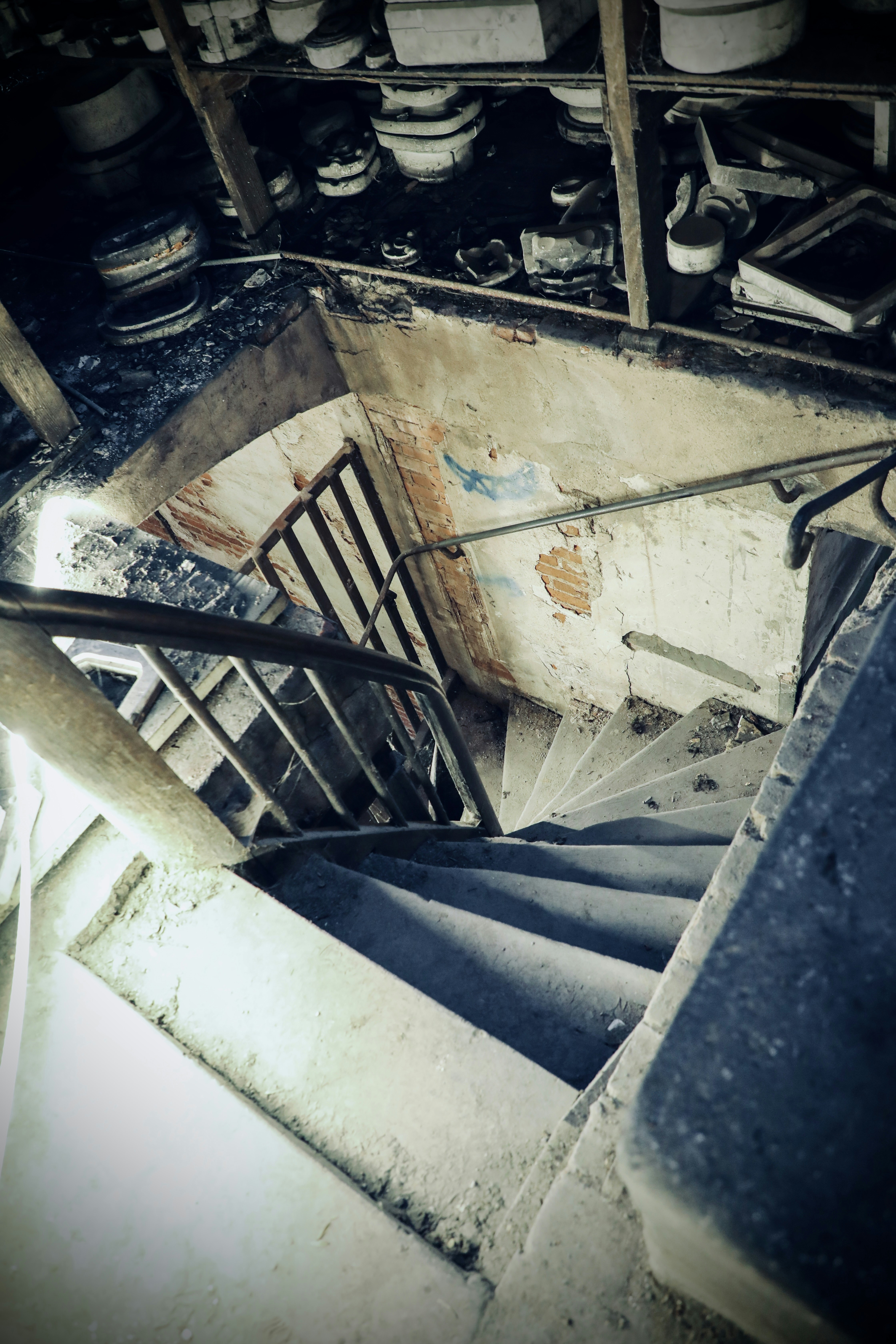A dark, old staircase descends into shadow.