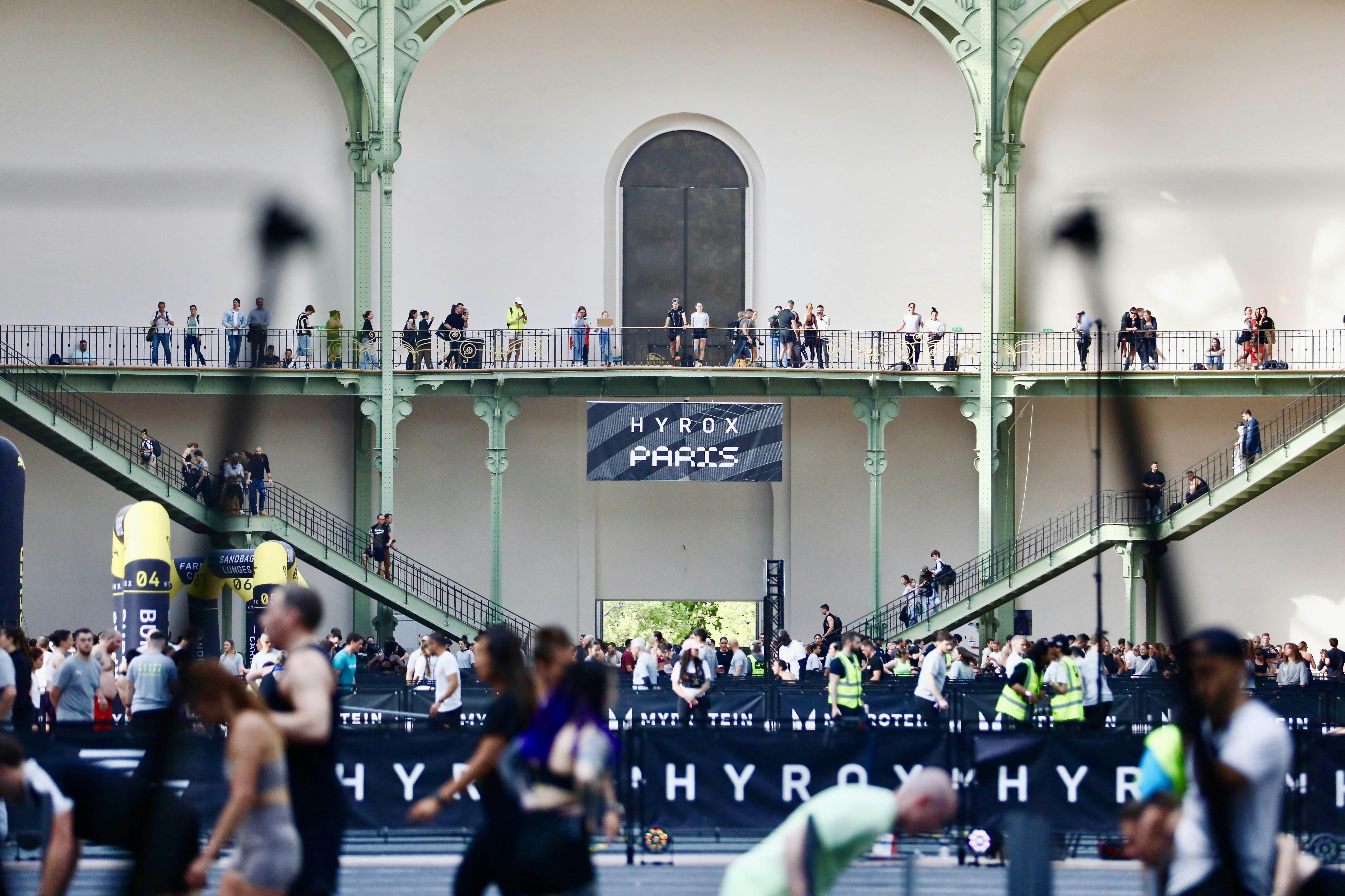 People gathered inside a large building with balconies.