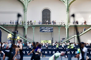 People gathered inside a large building with balconies.