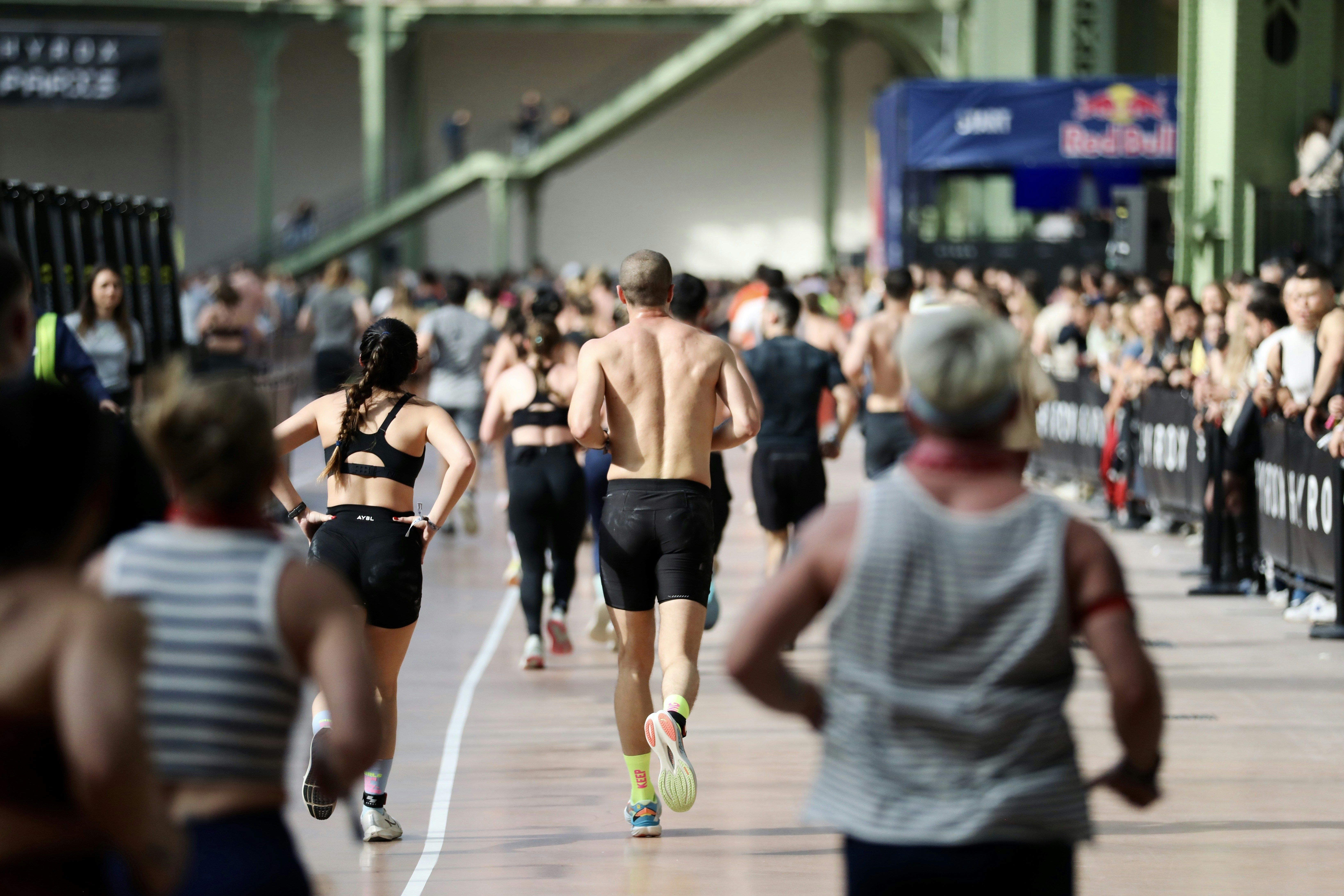 Athletes running in an indoor race event.