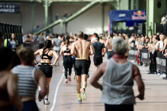 Athletes running in an indoor race event.