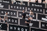Athletes compete in a hyrox event with puma branding.