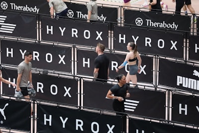 Athletes compete in a hyrox event with puma branding.