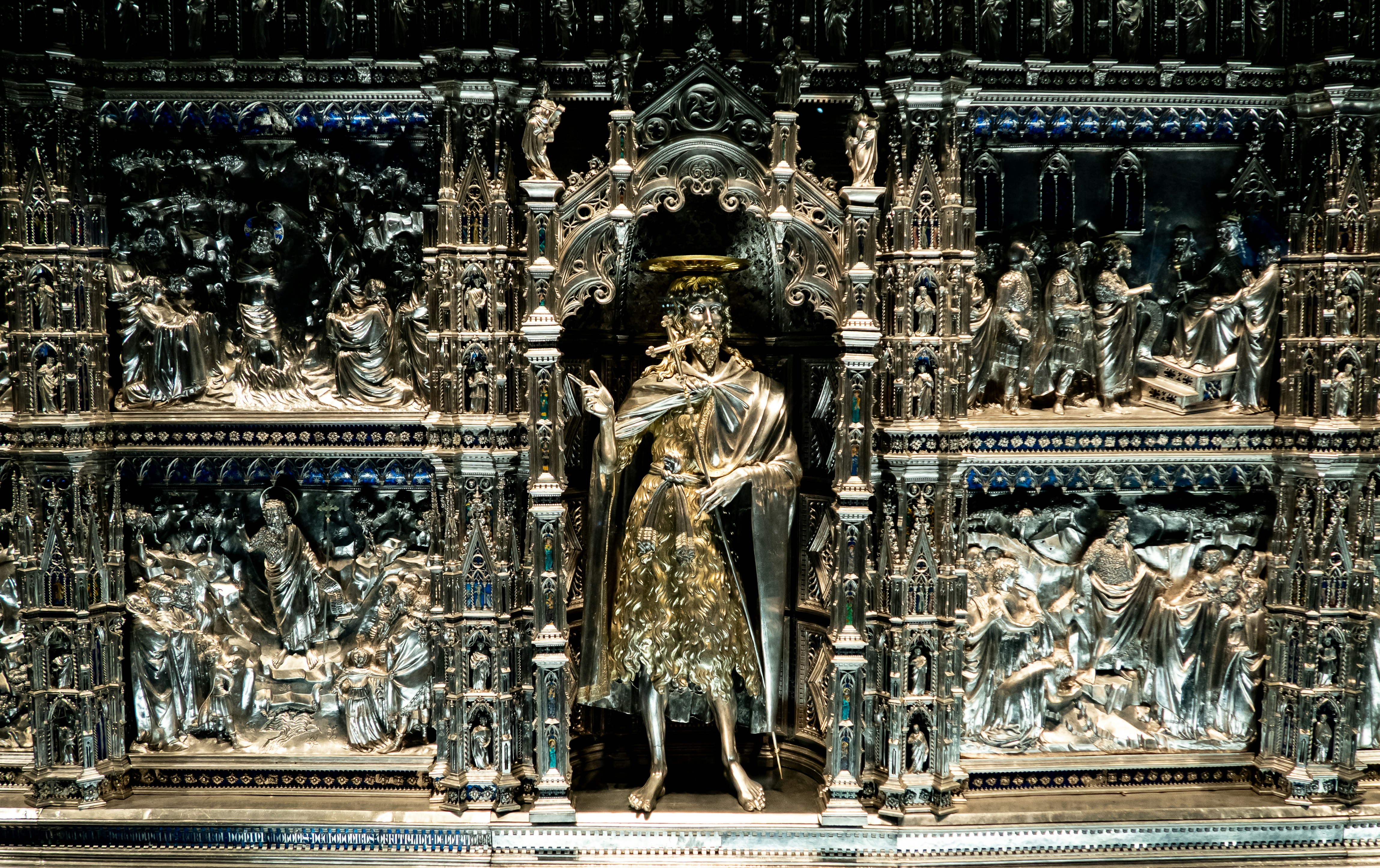 Ornate silver reliquary with central saint figure.