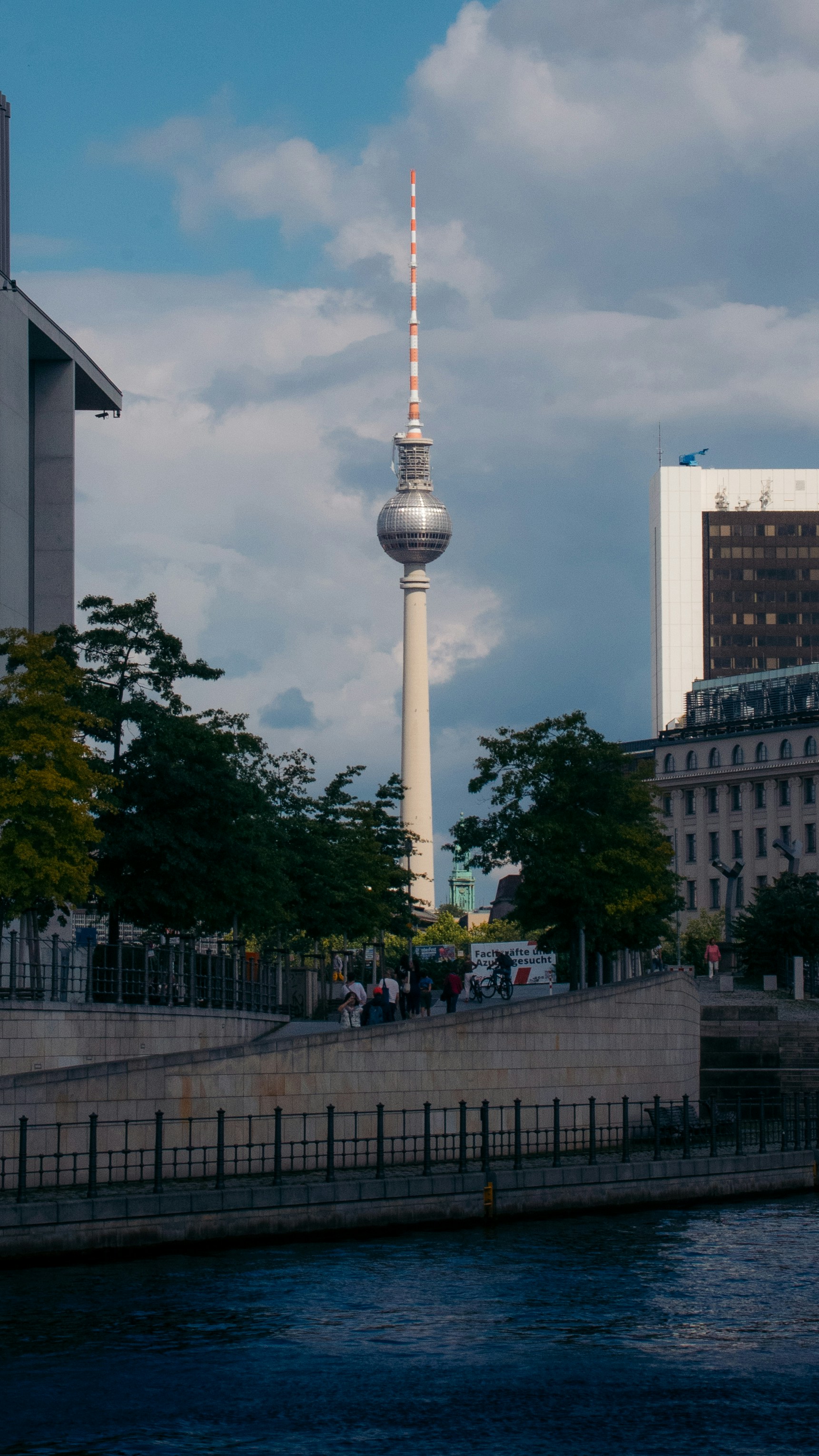 Fernsehturm tower and buildings by the river.