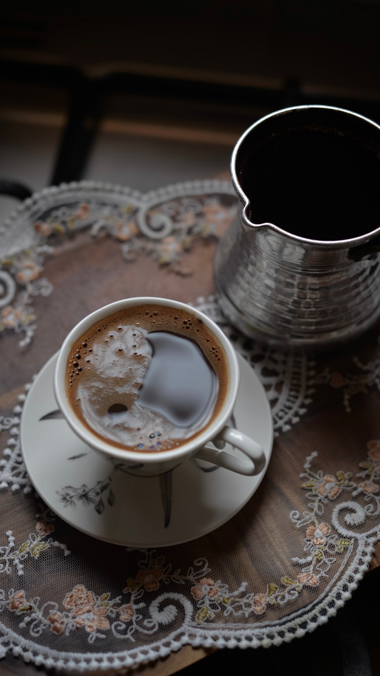 A cup of coffee and a cezve on a tray