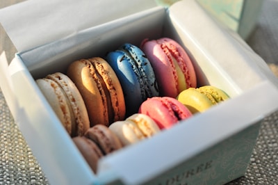 Colorful macarons arranged in a white box