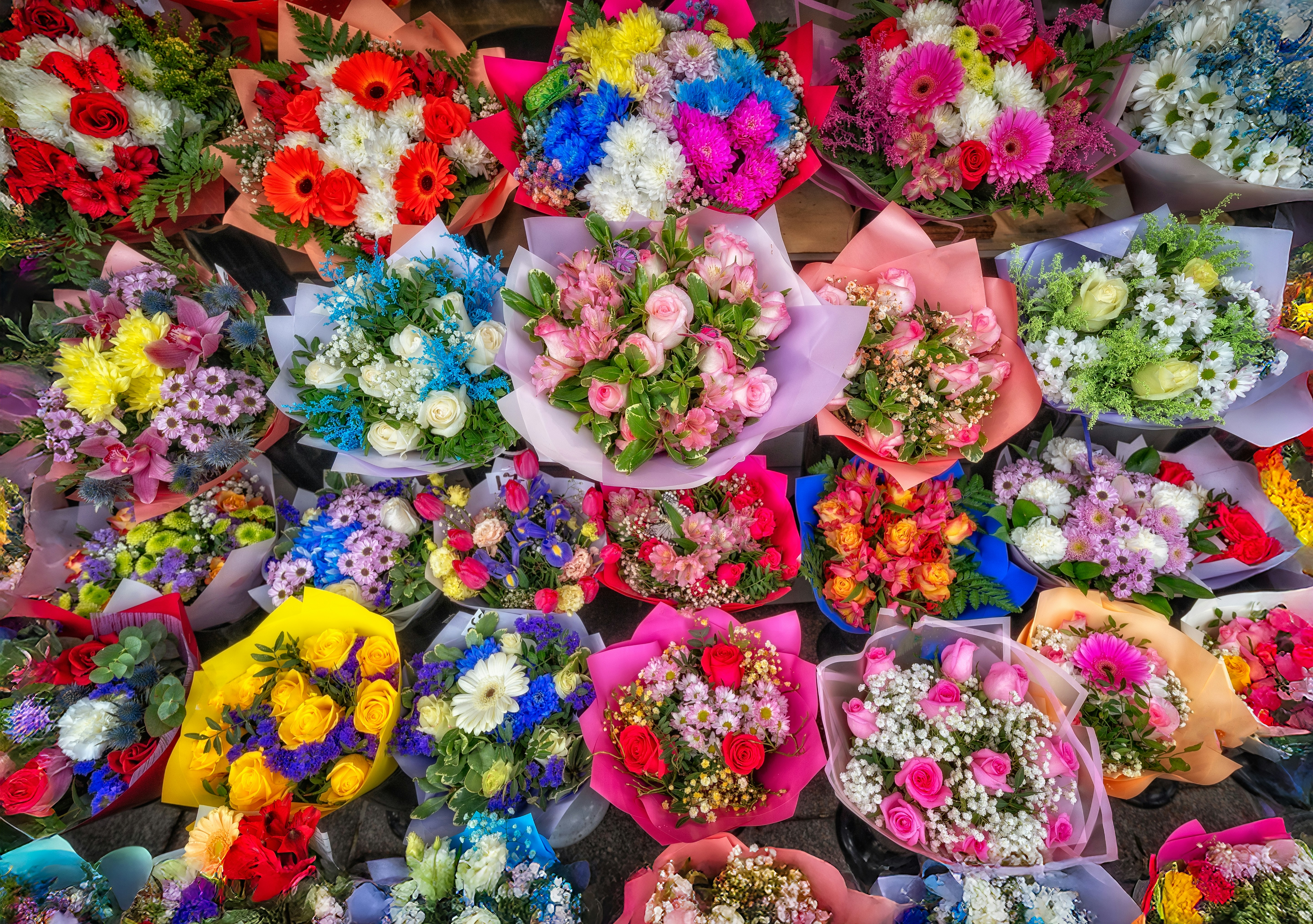 A vibrant display of assorted colorful flower bouquets.