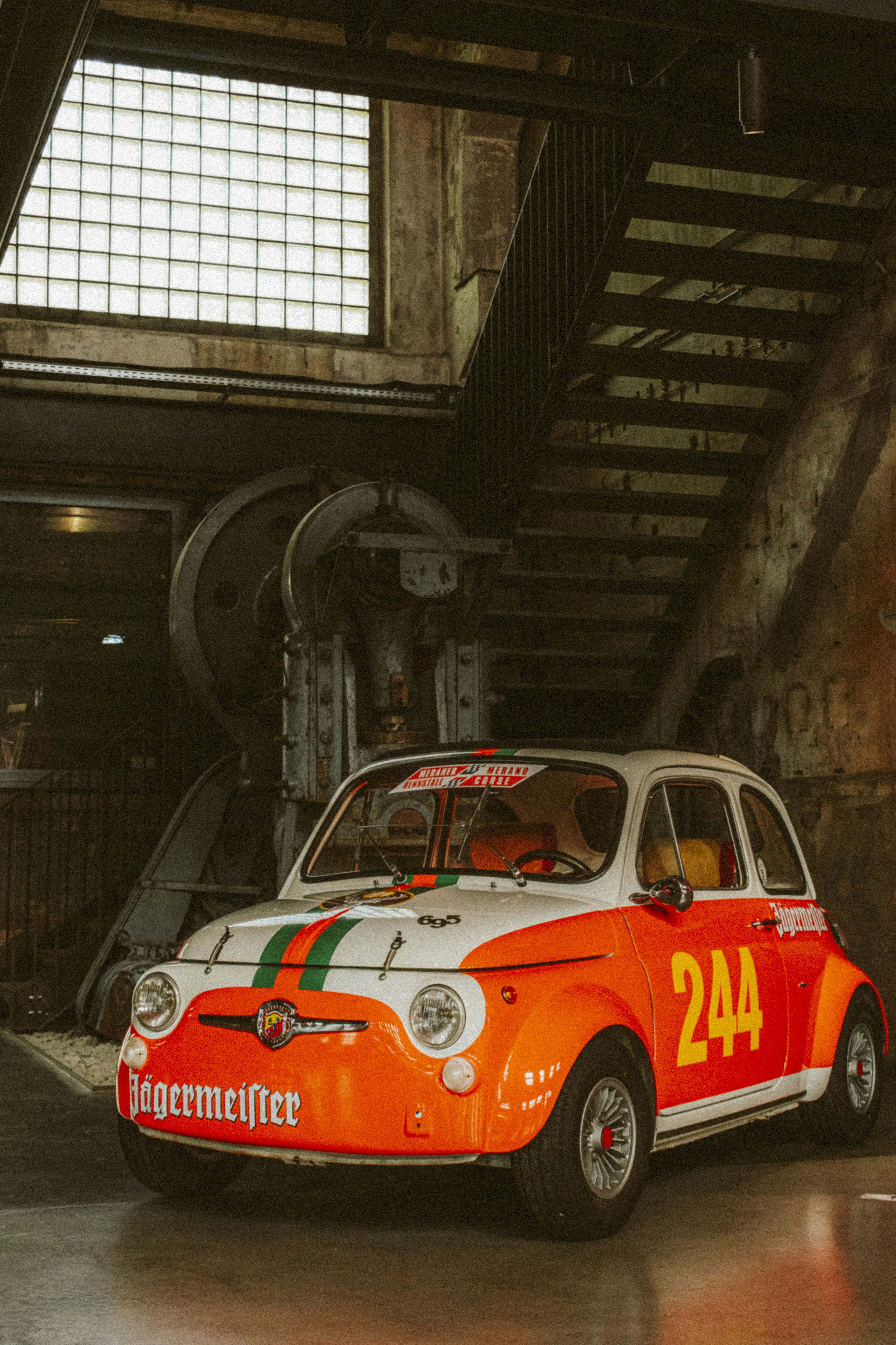 Vintage orange fiat 500 race car with jägermeister branding