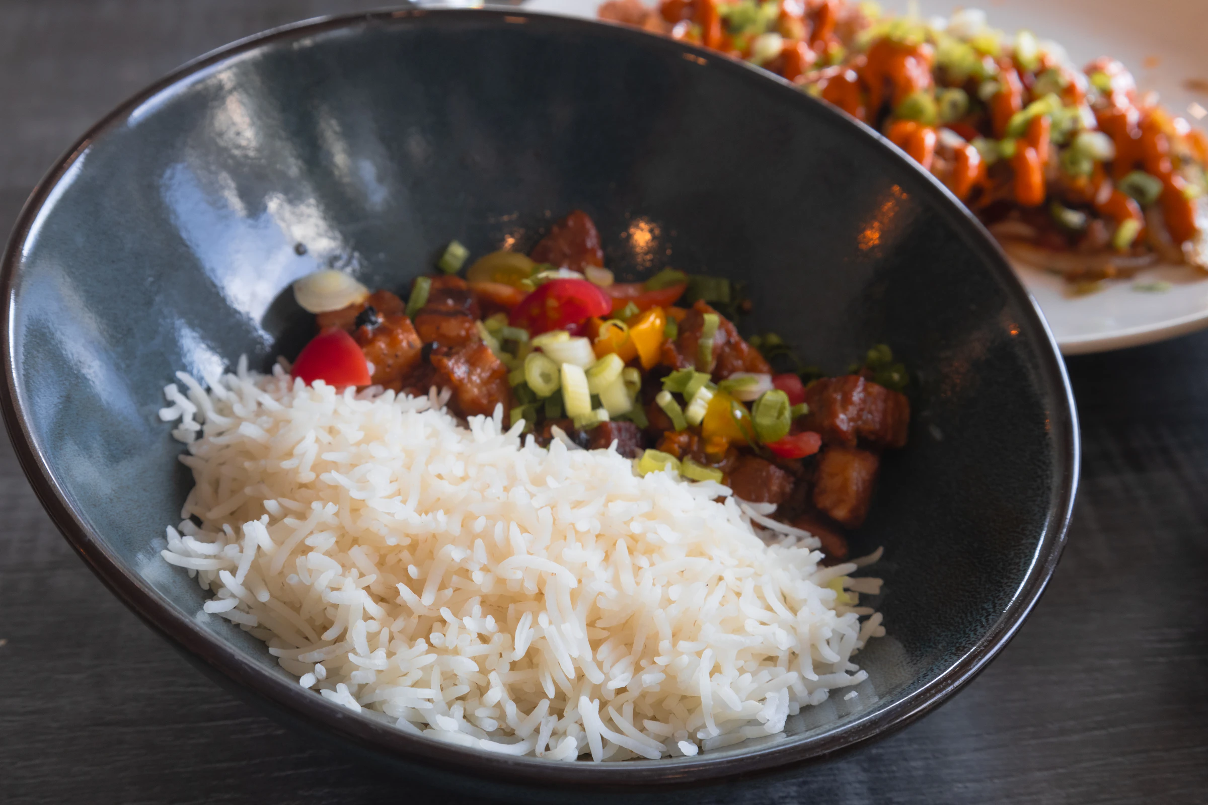 A bowl of rice with meat and vegetables