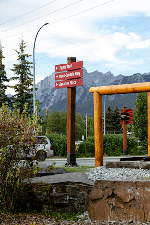 Red signpost directs to legacy trail and trans-canada highway.