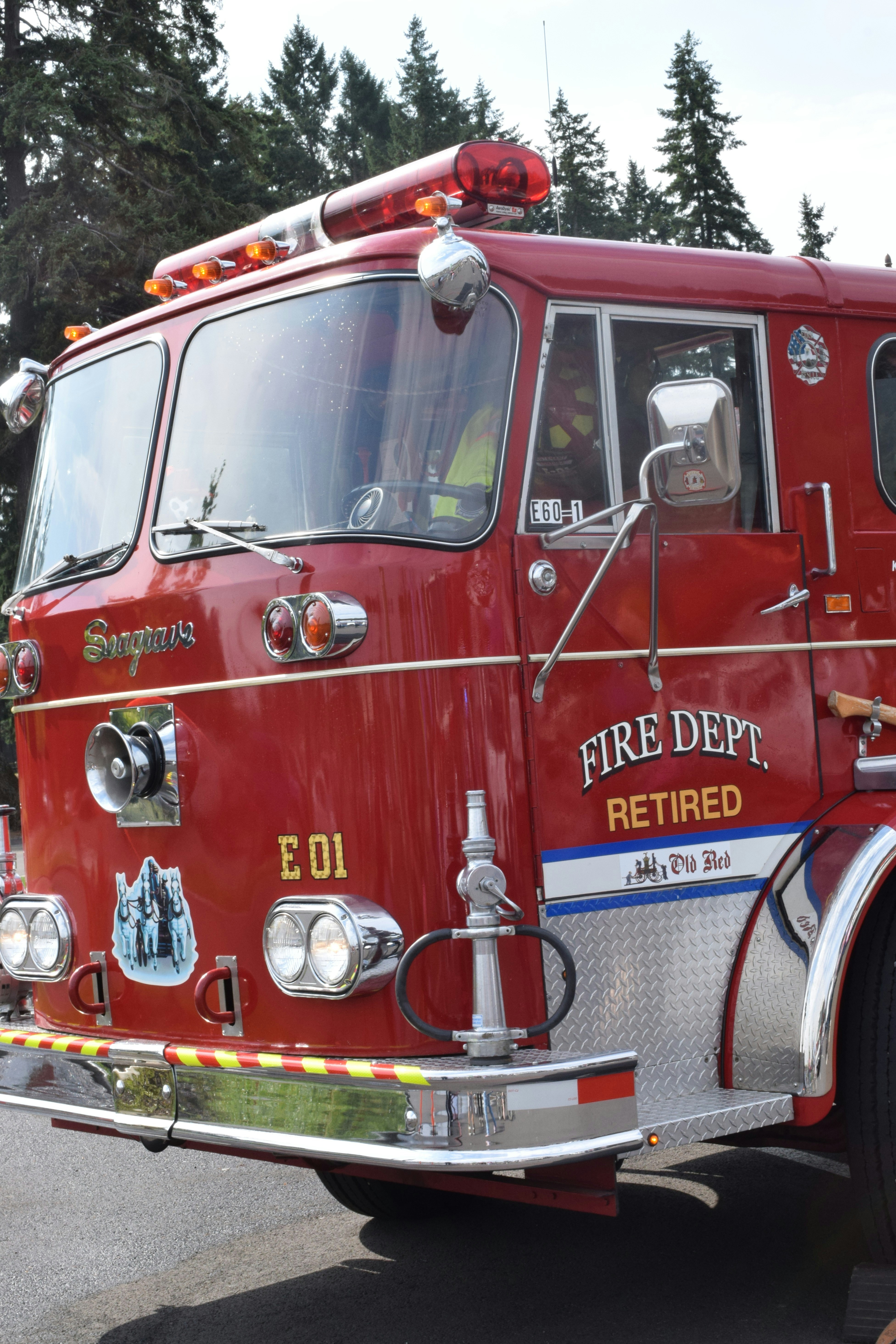 A red fire truck with "fire dept. retired" on its side.