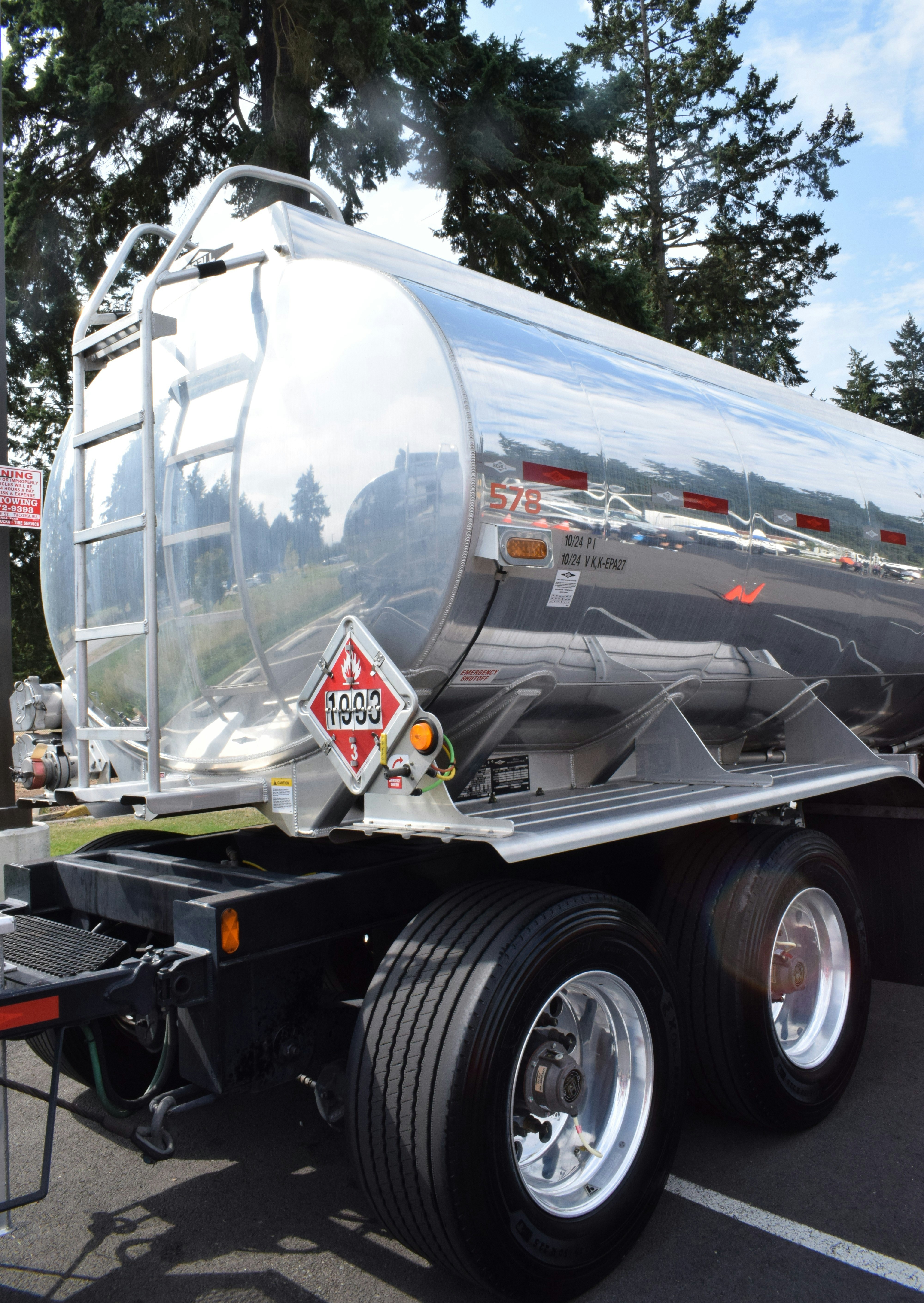 Shiny tanker truck with hazard symbols