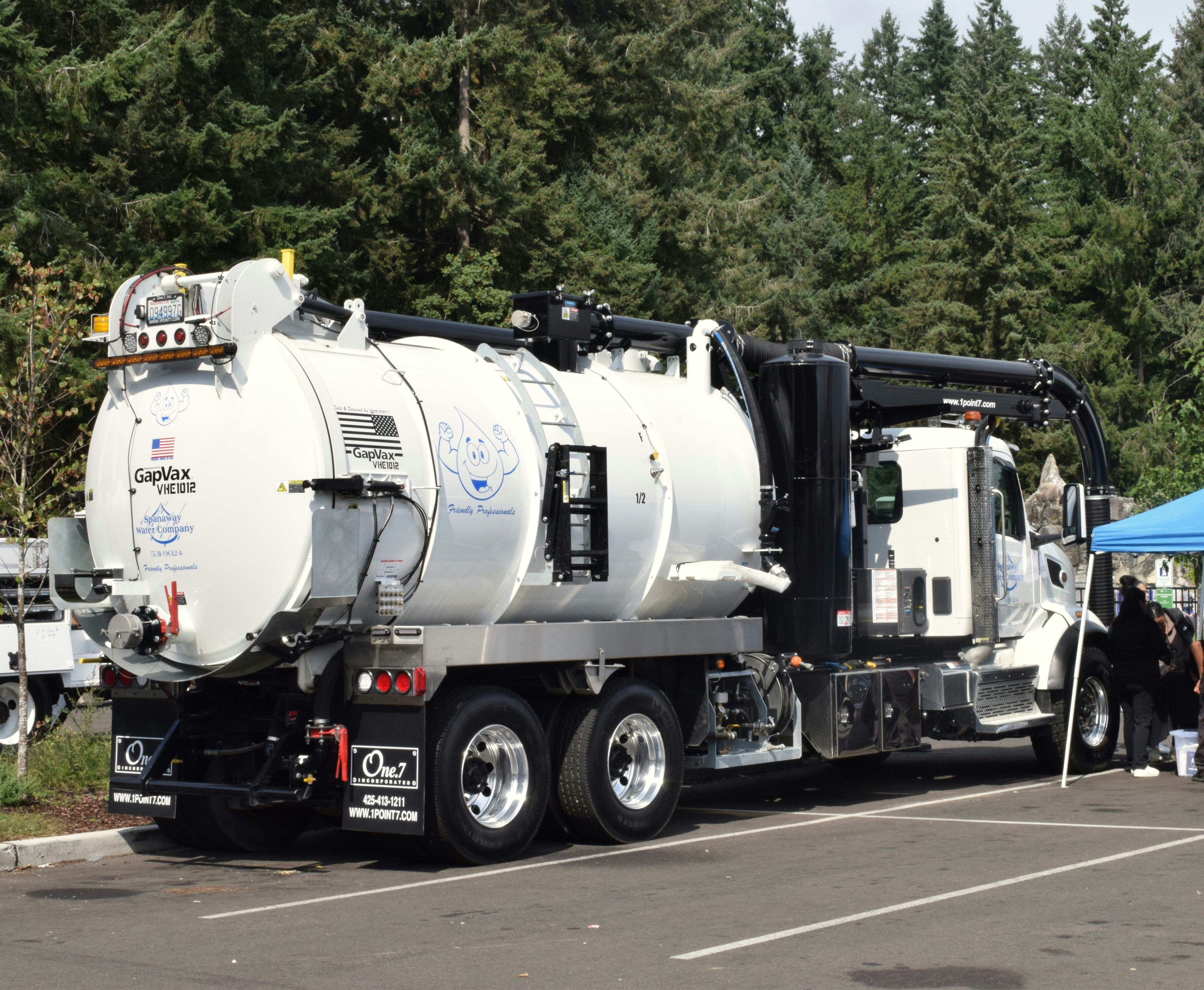 A large white vacuum truck parked outdoors