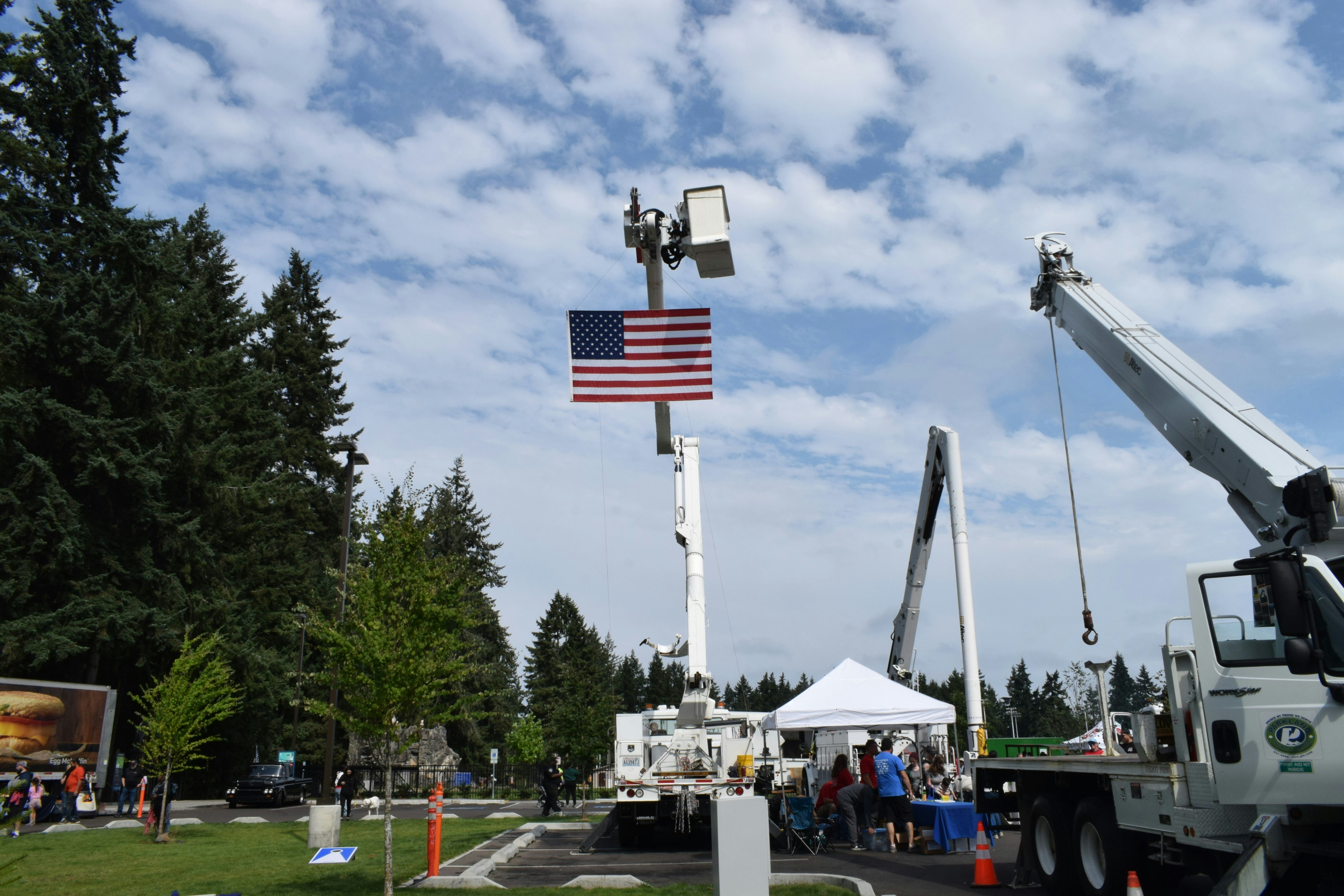 American flag displayed from a utility truck lift.