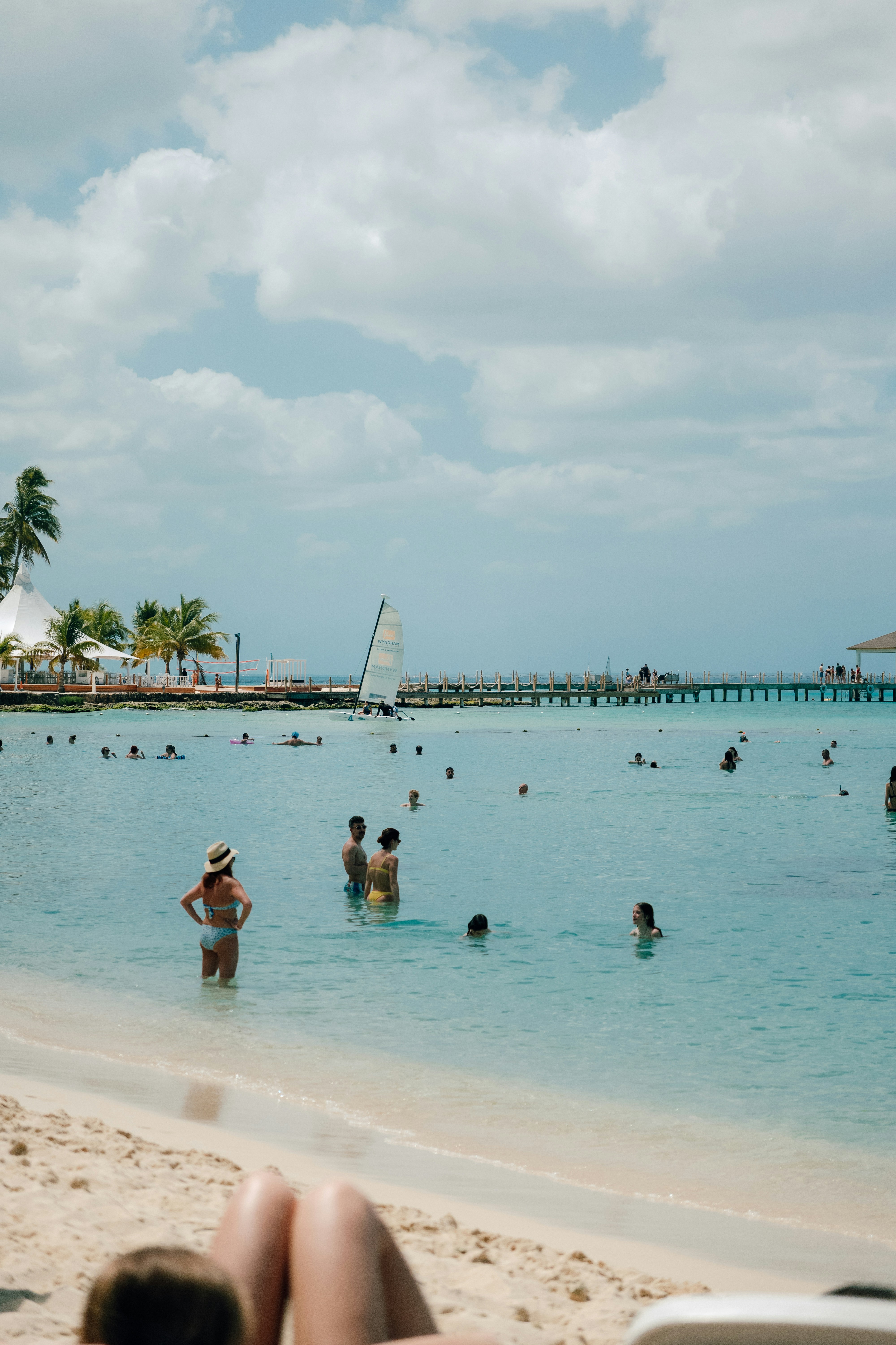People swimming and relaxing at a tropical beach resort.