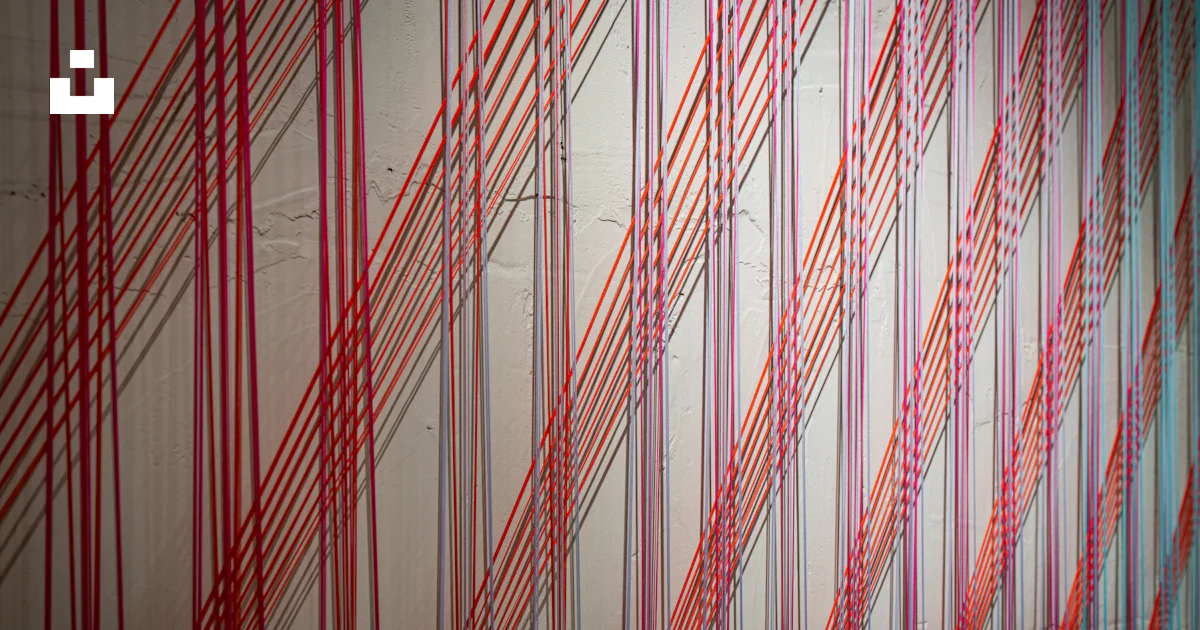 Red threads creating a striped pattern on a wall photo – Free Pattern ...