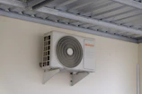 An air conditioning unit mounted on a wall.