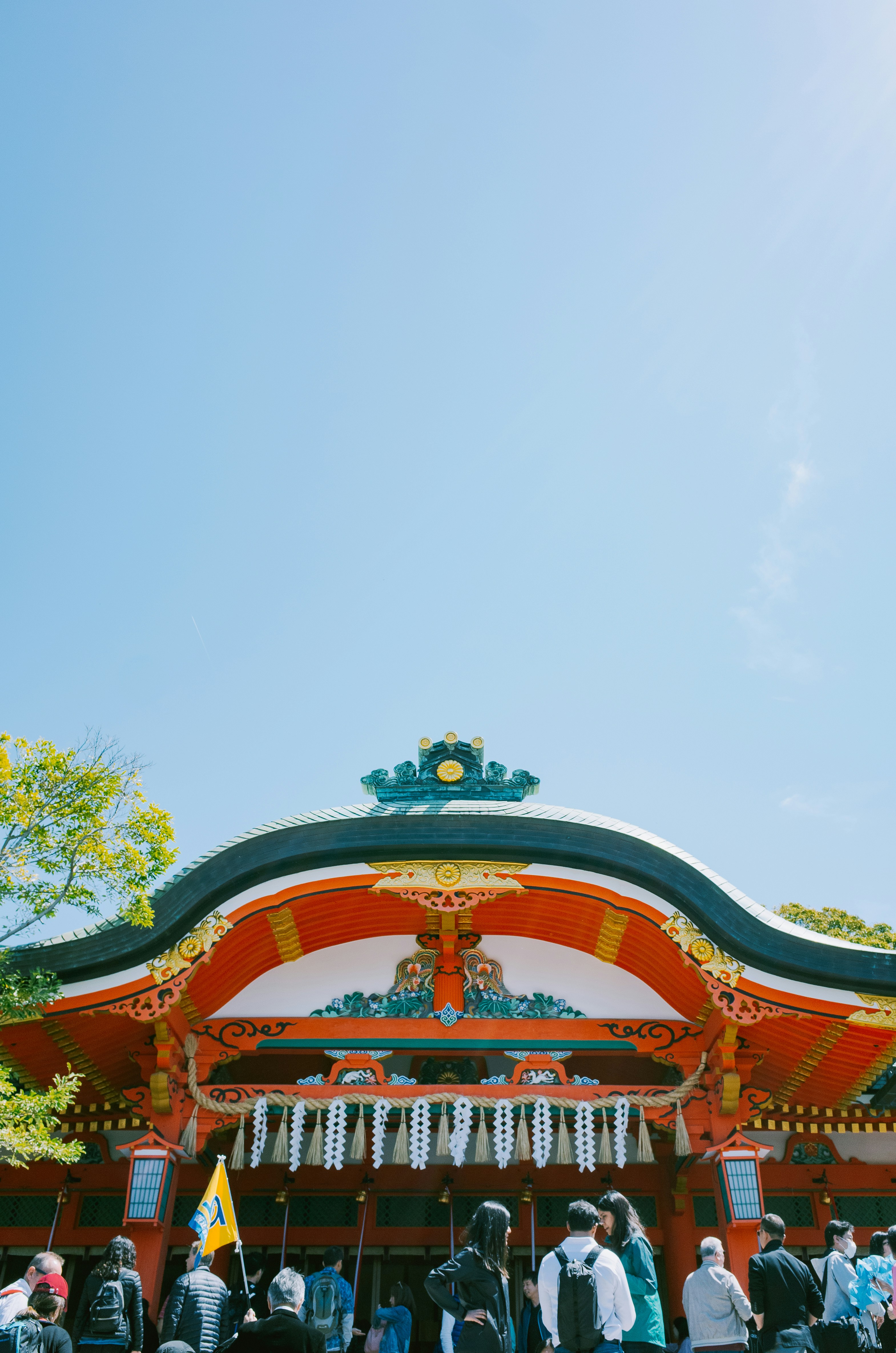 Japanese temple with people gathered outside