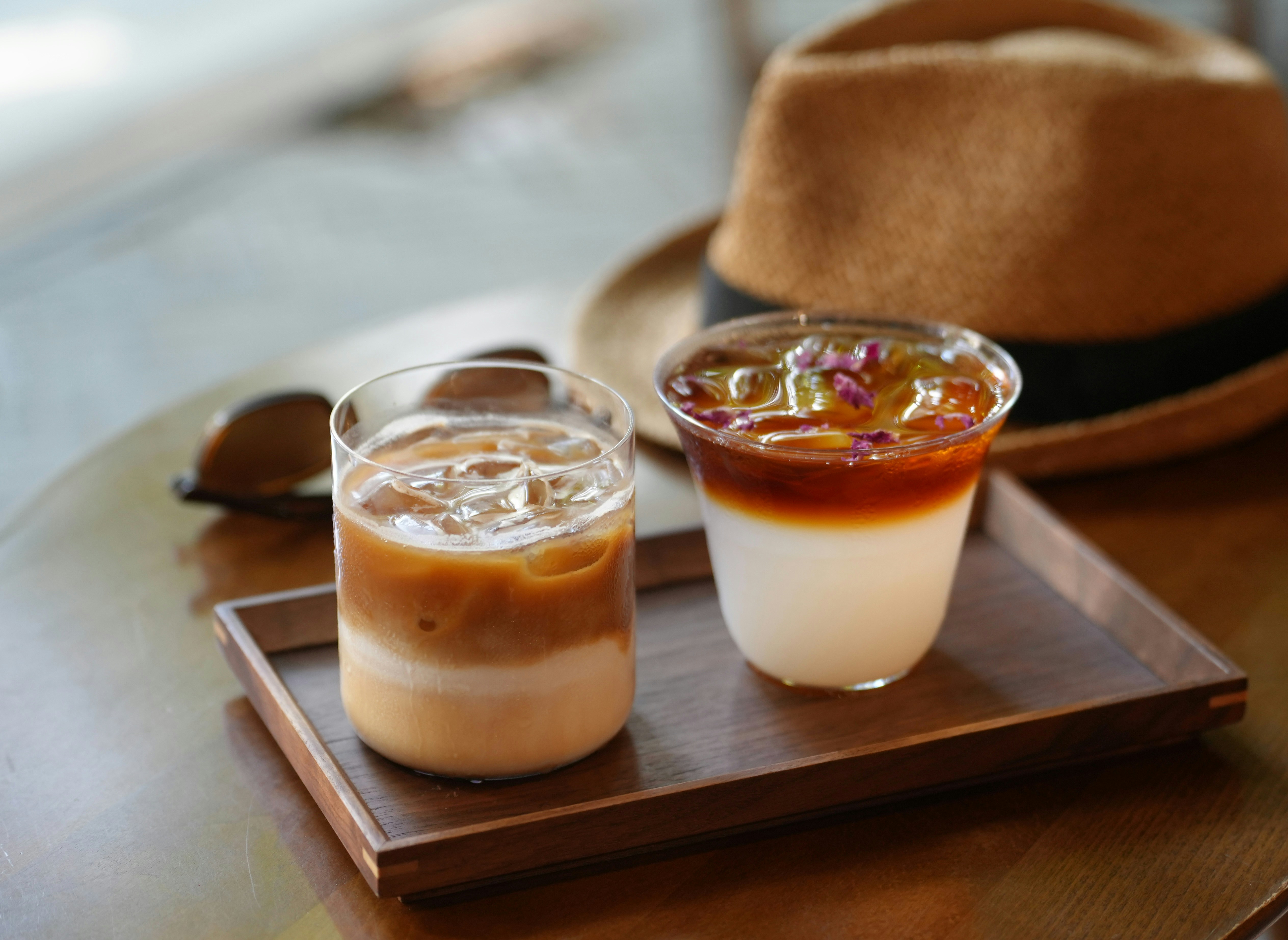Two refreshing drinks on a wooden tray