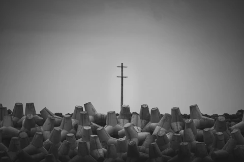 Tetrapods and telephone pole against sky