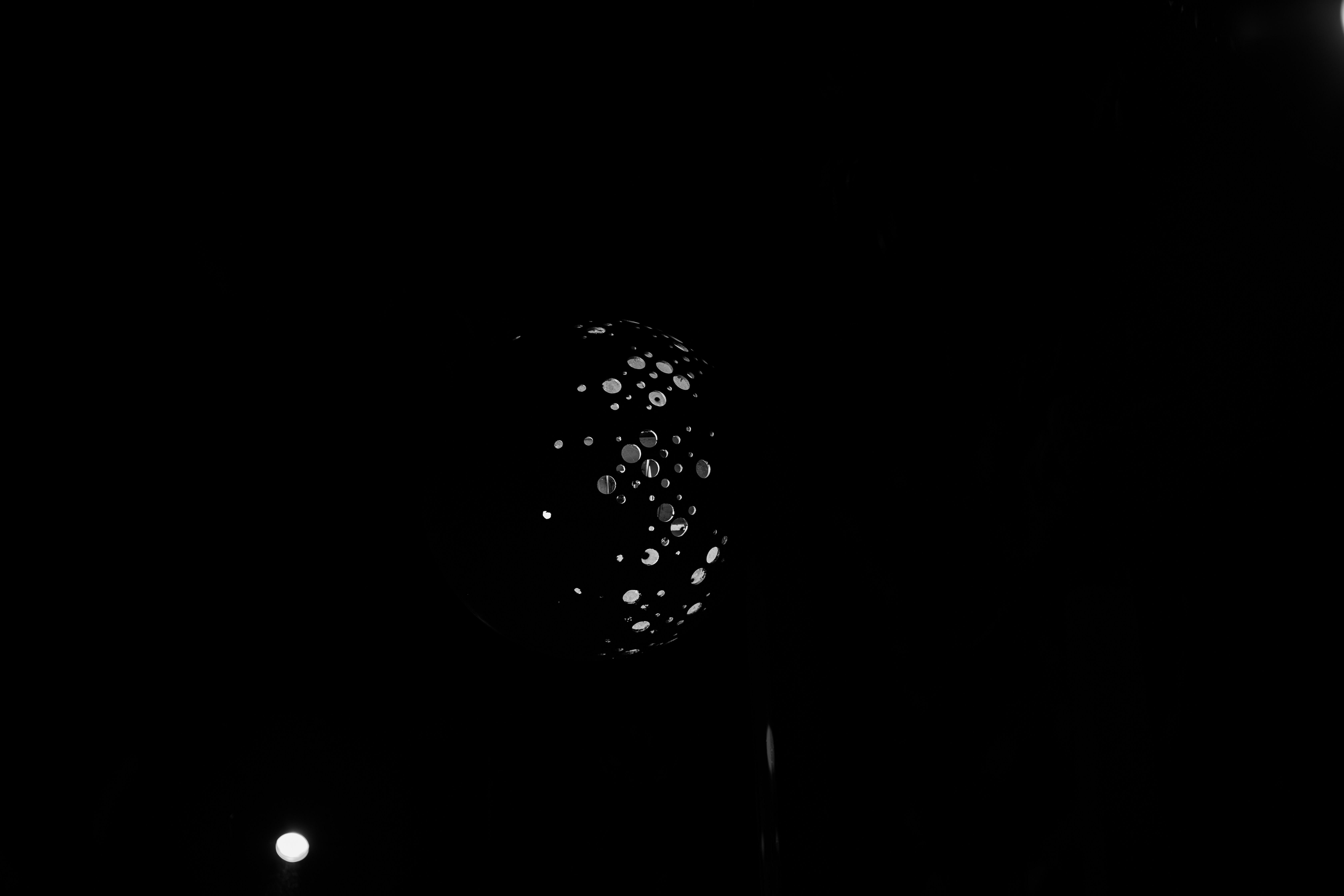 Abstract pattern of glowing orbs on black background